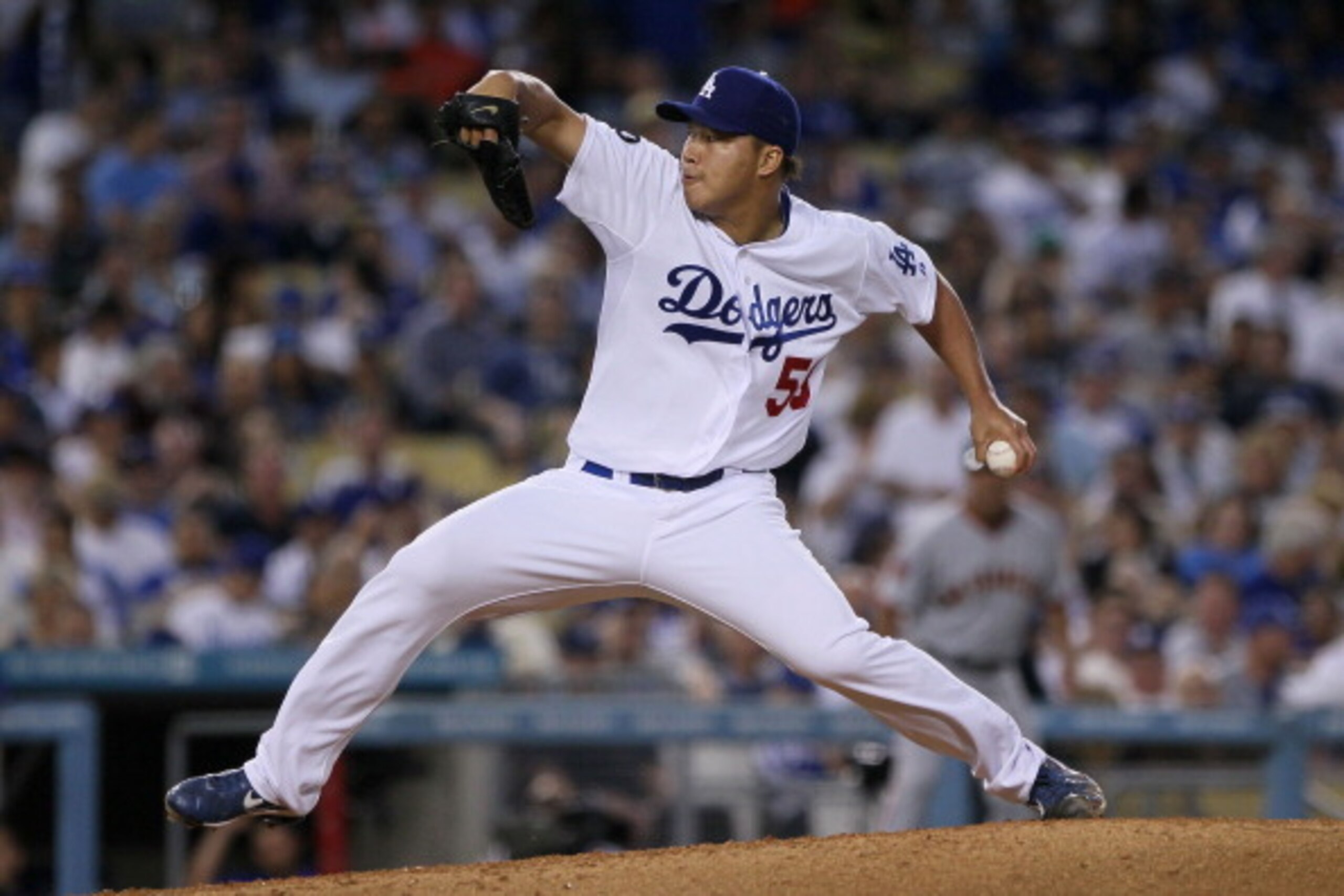 LOS ANGELES, CA - MARCH 31:  Hong-Chih Kuo #56 of the Los Angeles Dodgers throws a pitch against the San Francisco Giants in the eighth inning on Opening Day at Dodger Stadium on March 31, 2011 in Los Angeles, California.  (Photo by Jeff Gross/Getty Image