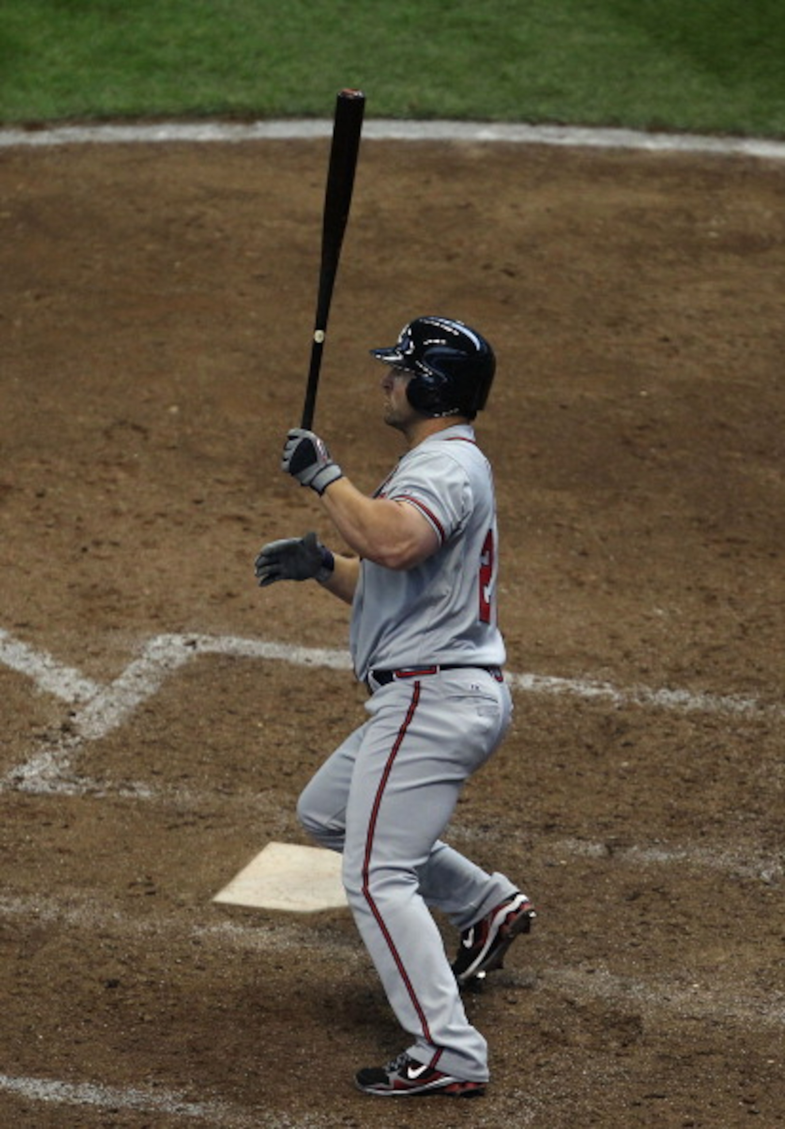 MILWAUKEE, WI - APRIL 04: Dan Uggla #26 of the Atlanta Braves follows the flight of his solo home run in the 8th inning against the Milwaukee Brewers during the home opener at Miller Park on April 4, 2011 in Milwaukee, Wisconsin. The Braves defeated the B