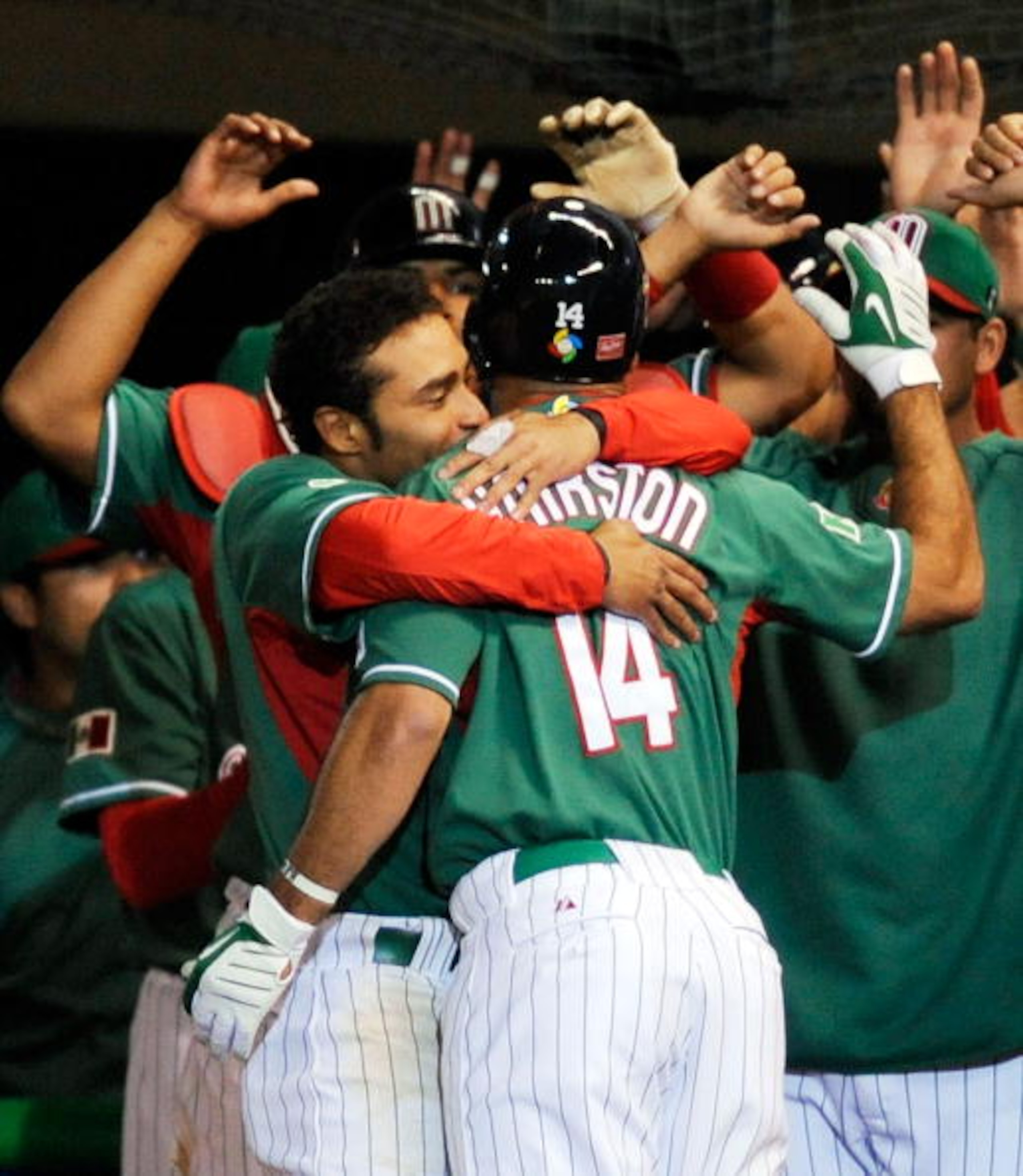 MEXICO CITY - MARCH 11:  Scott Hairston #14 of Mexico is congratulated by Jerry Hairston, Jr., (L) after hitting a two-run home run against Australia  during the 2009 World Baseball Classic Pool B match on March 11, 2009 at the Estadio Foro Sol in Mexico