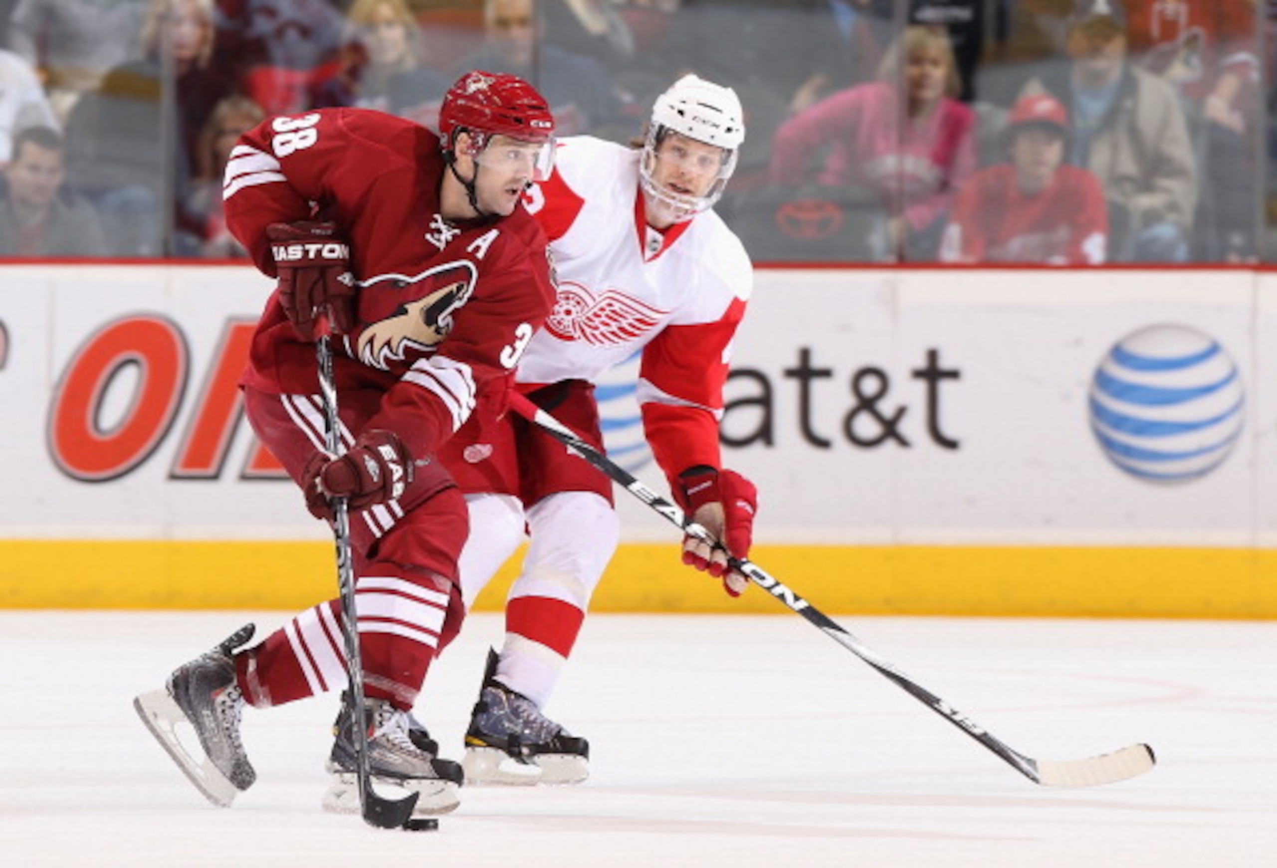 GLENDALE, AZ - MARCH 05:  Vernon Fiddler #38 of the Phoenix Coyotes skates with the puck past Brad Stuart #23 of the Detroit Red Wings during the NHL game at Jobing.com Arena on March 5, 2011 in Glendale, Arizona. The Coyotes defeated the Red Wings 5-4 in