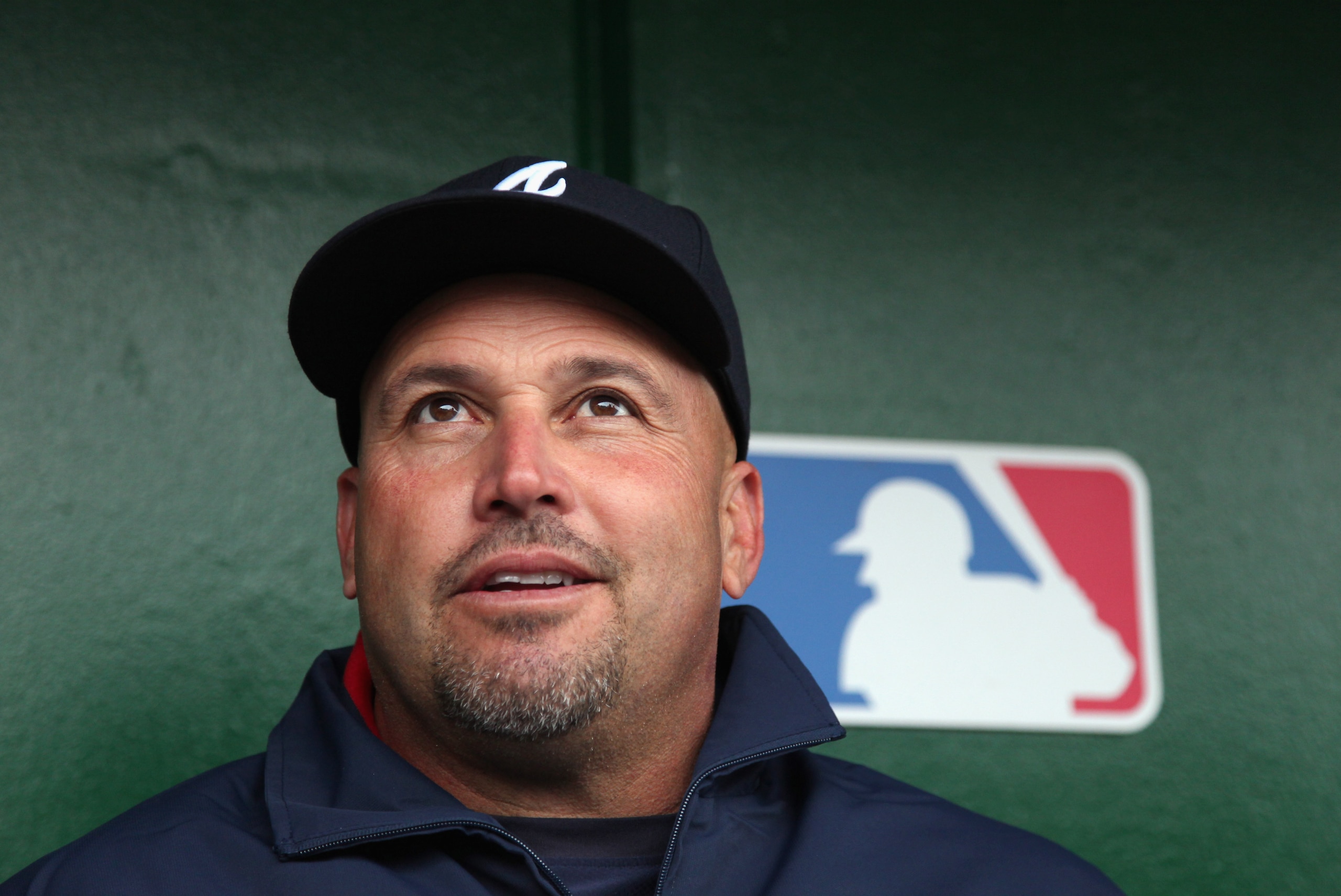 WASHINGTON, DC - MARCH 31:  Manager Fredi Gonzalez of the Atlanta Braves talks with the media in the dugout prior to their opening day game against the Washington Nationals at Nationals Park on March 31, 2011 in Washington, DC.  (Photo by Rob Carr/Getty I