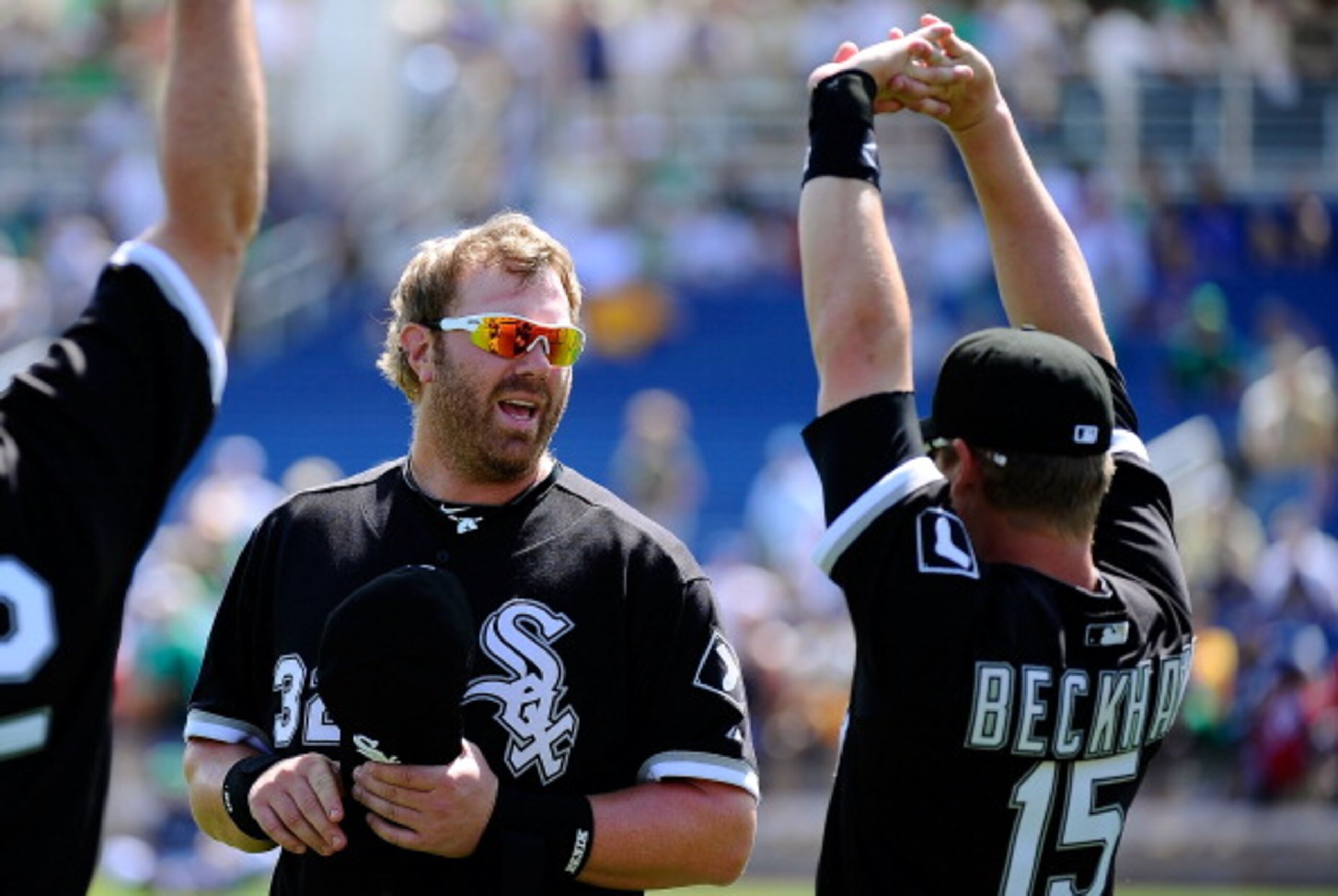 PHOENIX, AZ - MARCH 17:  Adam Dunn #32 of the Chicago White Sox talks to teammate Gordon Beckham #15 before playing against the Milwaukee Brewers during the spring training game at Maryvale Baseball Park on March 17, 2011 in Phoenix, Arizona.  (Photo by K
