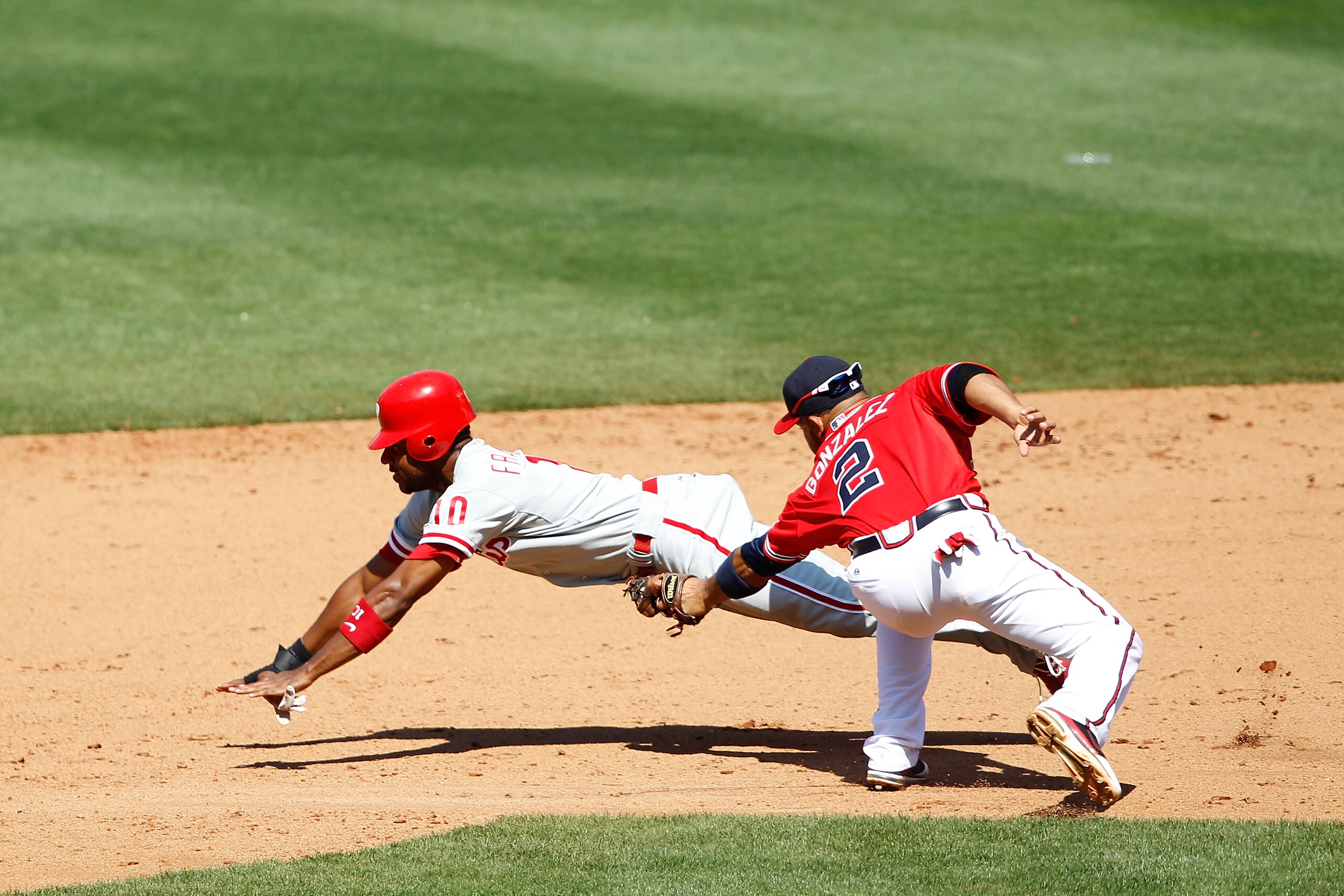 ATLANTA, GA - APRIL 10: Alex Gonzalez #2 of the Atlanta Braves tags out Ben Francisco #10 of the Philadelphia Phillies after he was caught stealing at Turner Field on April 10, 2011 in Atlanta, Georgia. The Phillies won 3-0. (Photo by Joe Robbins/Getty Im