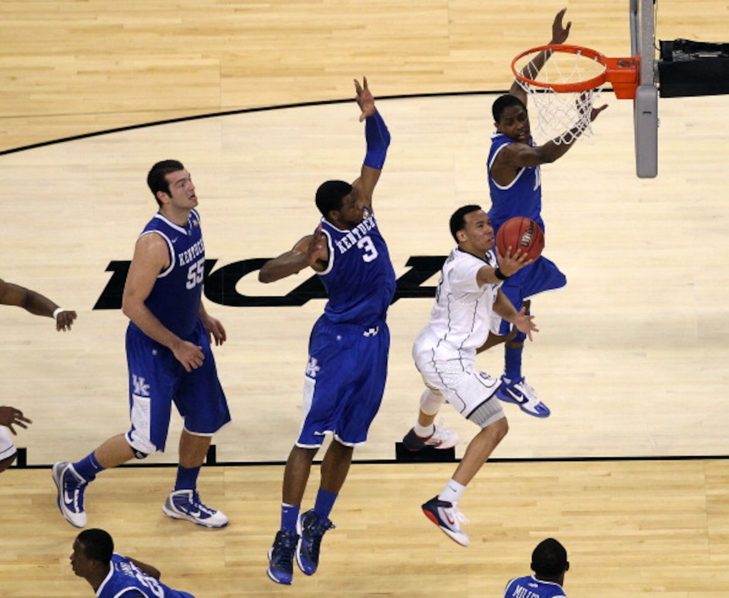 HOUSTON, TX - APRIL 02: Shabazz Napier #13 of the Connecticut Huskies goes to the hoop against Terrence Jones #3 and Brandon Knight #12 of the Kentucky Wildcats during the National Semifinal game of the 2011 NCAA Division I Men's Basketball Championship HOUSTON, TX - APRIL 02: Shabazz Napier #13 of the Connecticut Huskies goes to the hoop against Terrence Jones #3 and Brandon Knight #12 of the Kentucky Wildcats during the National Semifinal game of the 2011 NCAA Division I Men's Basketball Championship