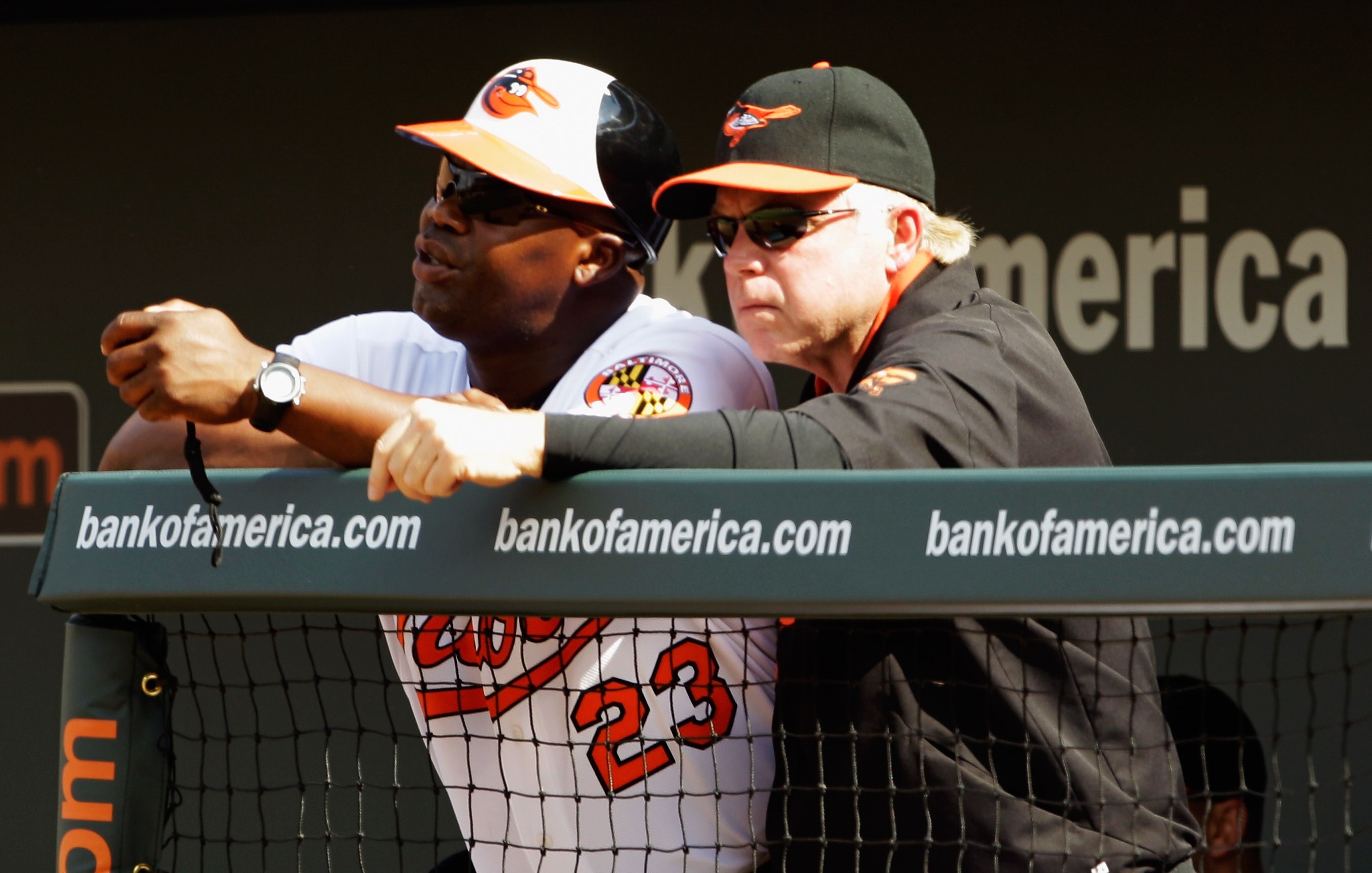 BALTIMORE, MD - APRIL 04: Manager Buck Showalter #26 of the Baltimore Orioles (R) talks with coach Wayne Kirby during opening day against the Detroit Tigers at Oriole Park at Camden Yards on April 4, 2011 in Baltimore, Maryland.  (Photo by Rob Carr/Getty