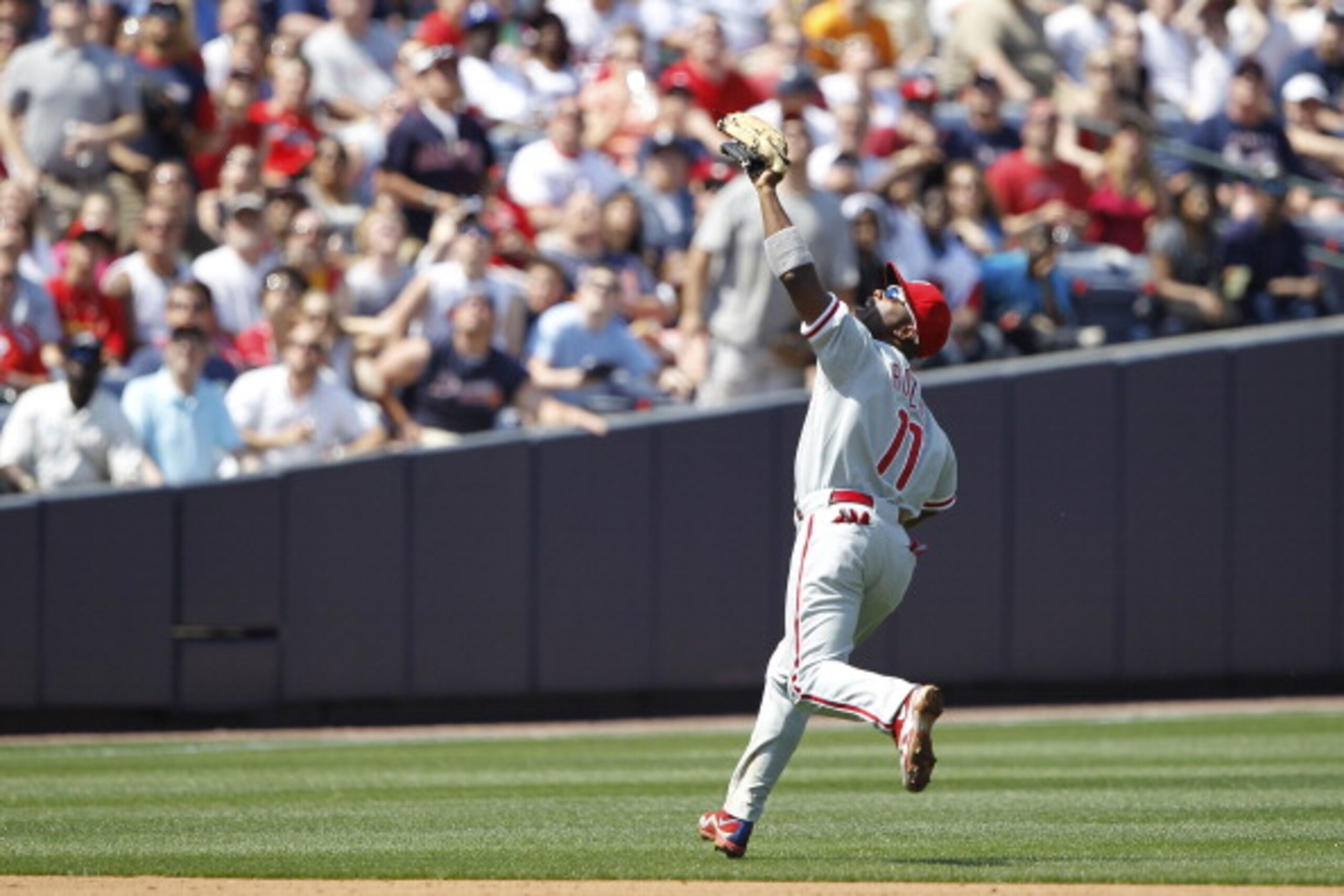 ATLANTA, GA - APRIL 10: Jimmy Rollins #11 of the Philadelphia Phillies shields his eyes from the sun while running down a fly ball against the Atlanta Braves at Turner Field on April 10, 2011 in Atlanta, Georgia. The Phillies won 3-0. (Photo by Joe Robbin ATLANTA, GA - APRIL 10: Jimmy Rollins #11 of the Philadelphia Phillies shields his eyes from the sun while running down a fly ball against the Atlanta Braves at Turner Field on April 10, 2011 in Atlanta, Georgia. The Phillies won 3-0. (Photo by Joe Robbin