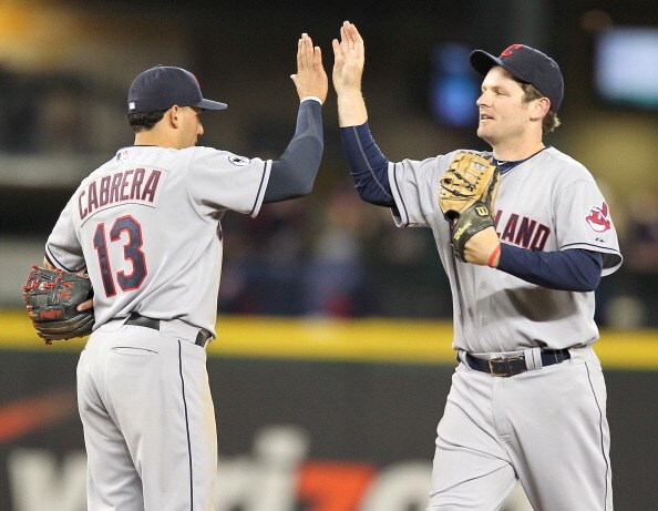 SEATTLE - APRIL 08:  Austin Kearns #26 of the Cleveland Indians congratulates Asdrubal Cabrera #13 after defeating the Seattle Mariners 12-3 at the Mariners' home opener at Safeco Field on April 8, 2011 in Seattle, Washington. (Photo by Otto Greule Jr/Get