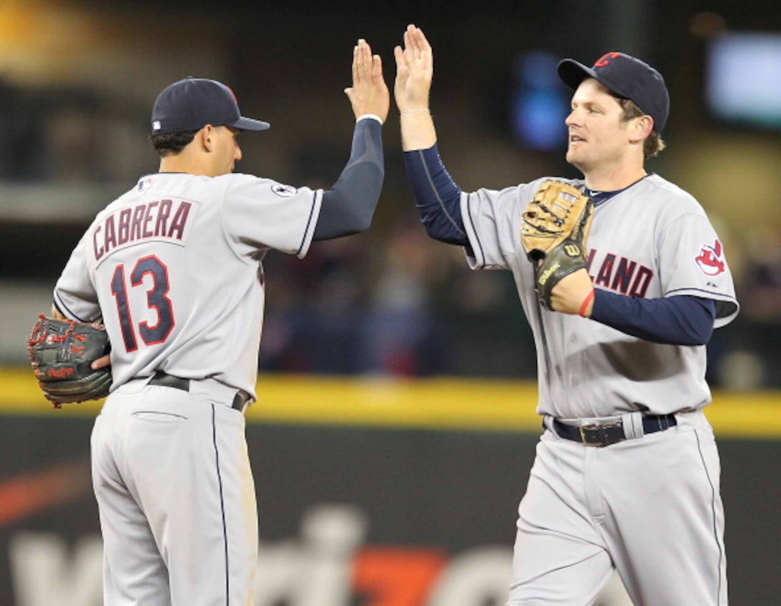 SEATTLE - APRIL 08: Austin Kearns #26 of the Cleveland Indians congratulates Asdrubal Cabrera #13 after defeating the Seattle Mariners 12-3 at the Mariners' home opener at Safeco Field on April 8, 2011 in Seattle, Washington. (Photo by Otto Greule Jr/Get SEATTLE - APRIL 08: Austin Kearns #26 of the Cleveland Indians congratulates Asdrubal Cabrera #13 after defeating the Seattle Mariners 12-3 at the Mariners' home opener at Safeco Field on April 8, 2011 in Seattle, Washington. (Photo by Otto Greule Jr/Get