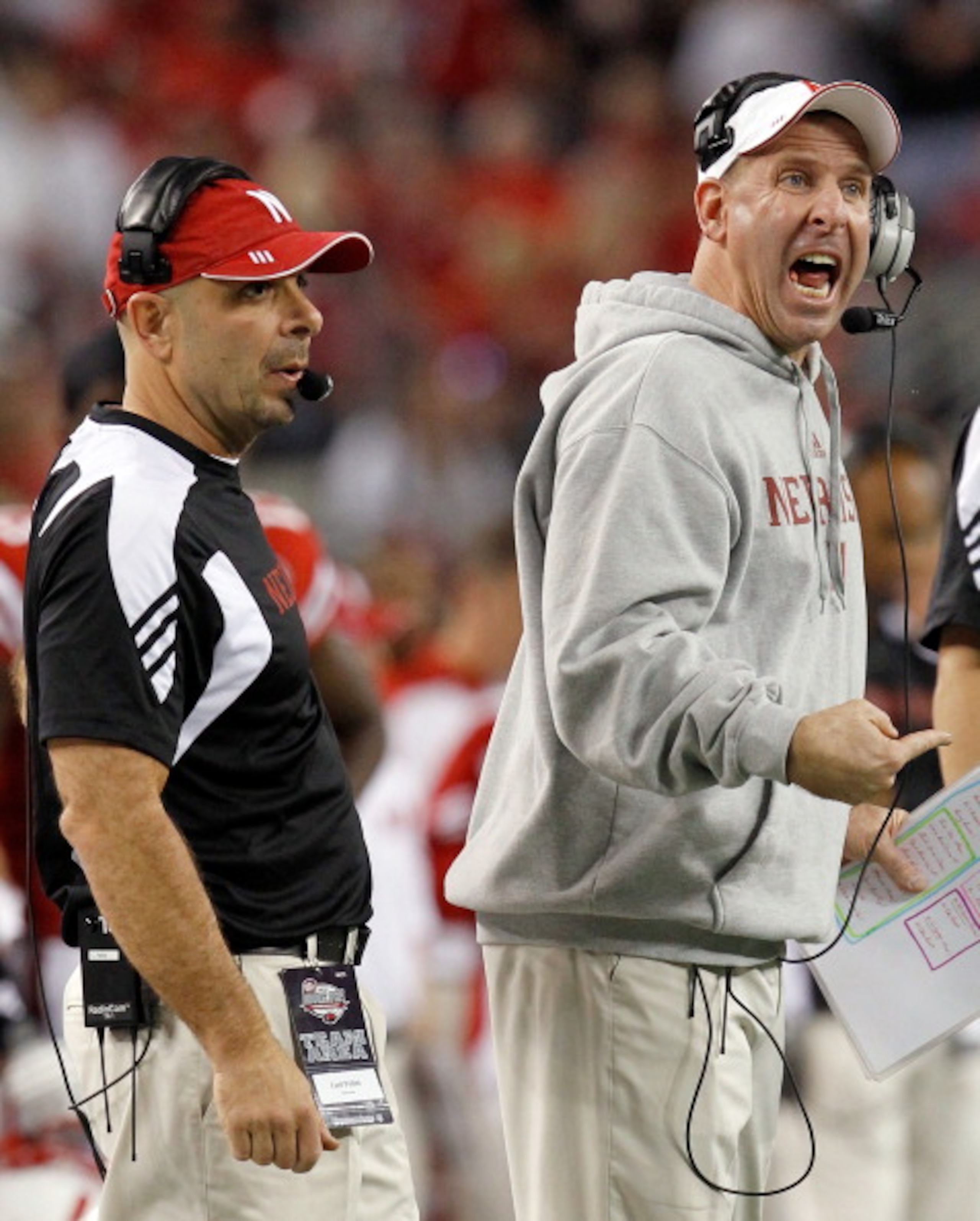 ARLINGTON, TX - DECEMBER 04:  Head coach Bo Pelini (R) of the Nebraska Cornhuskers and defensive coordinator Carl Pelini lead their team against the Oklahoma Sooners at Cowboys Stadium on December 4, 2010 in Arlington, Texas. The Sooners beat the Cornhusk