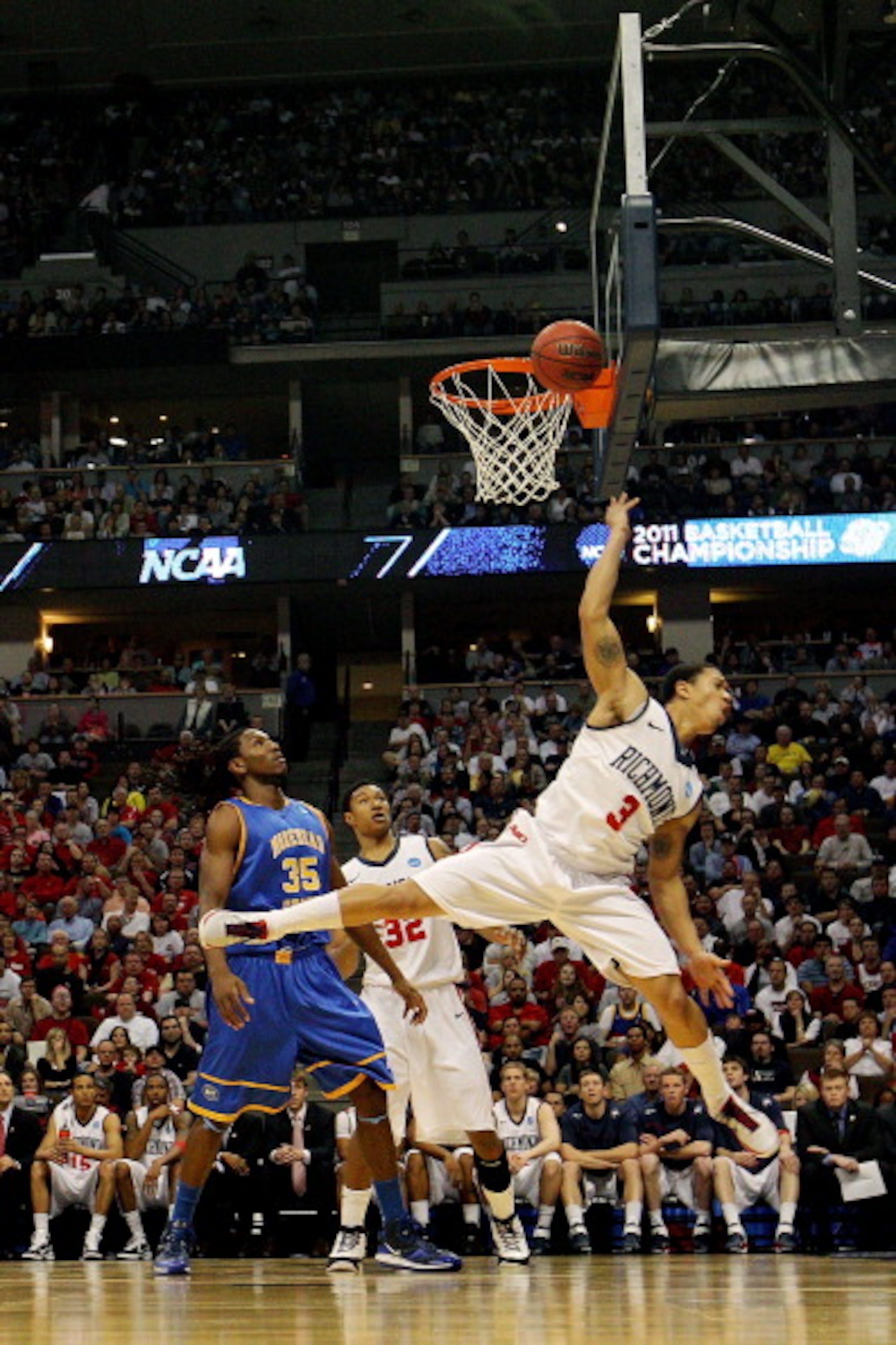 DENVER, CO - MARCH 19:  Darien Brothers #3 of the Richmond Spiders goes to the basket against Kenneth Faried #35 of the Morehead State Eagles during the third round of the 2011 NCAA men's basketball tournament at Pepsi Center on March 19, 2011 in Denver,