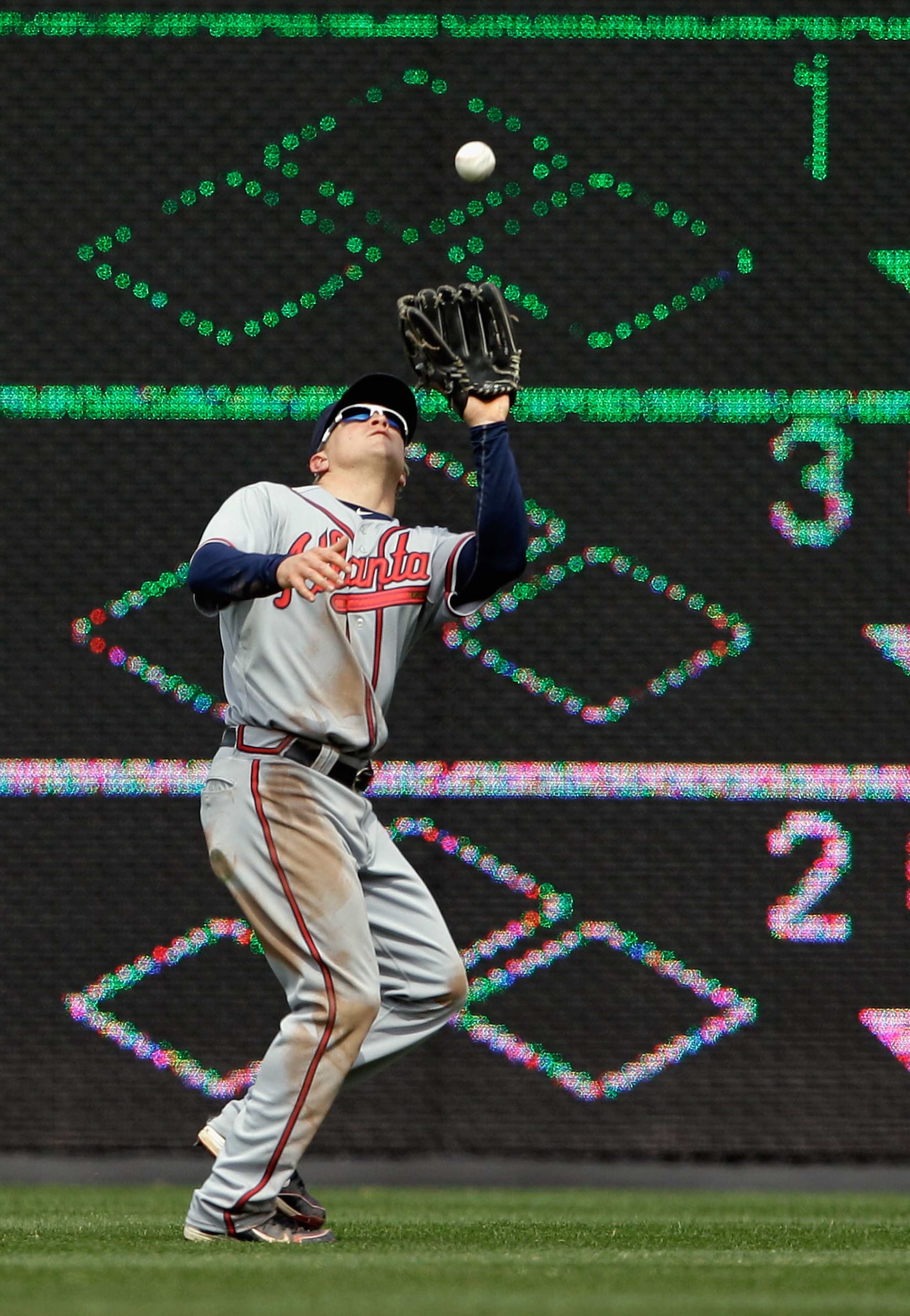 WASHINGTON, DC - APRIL 03: Outfielder Nate McLouth #13 of the Atlanta Braves catches a ball hit by a Washington Nationals batter at Nationals Park on April 3, 2011 in Washington, DC.  (Photo by Rob Carr/Getty Images)