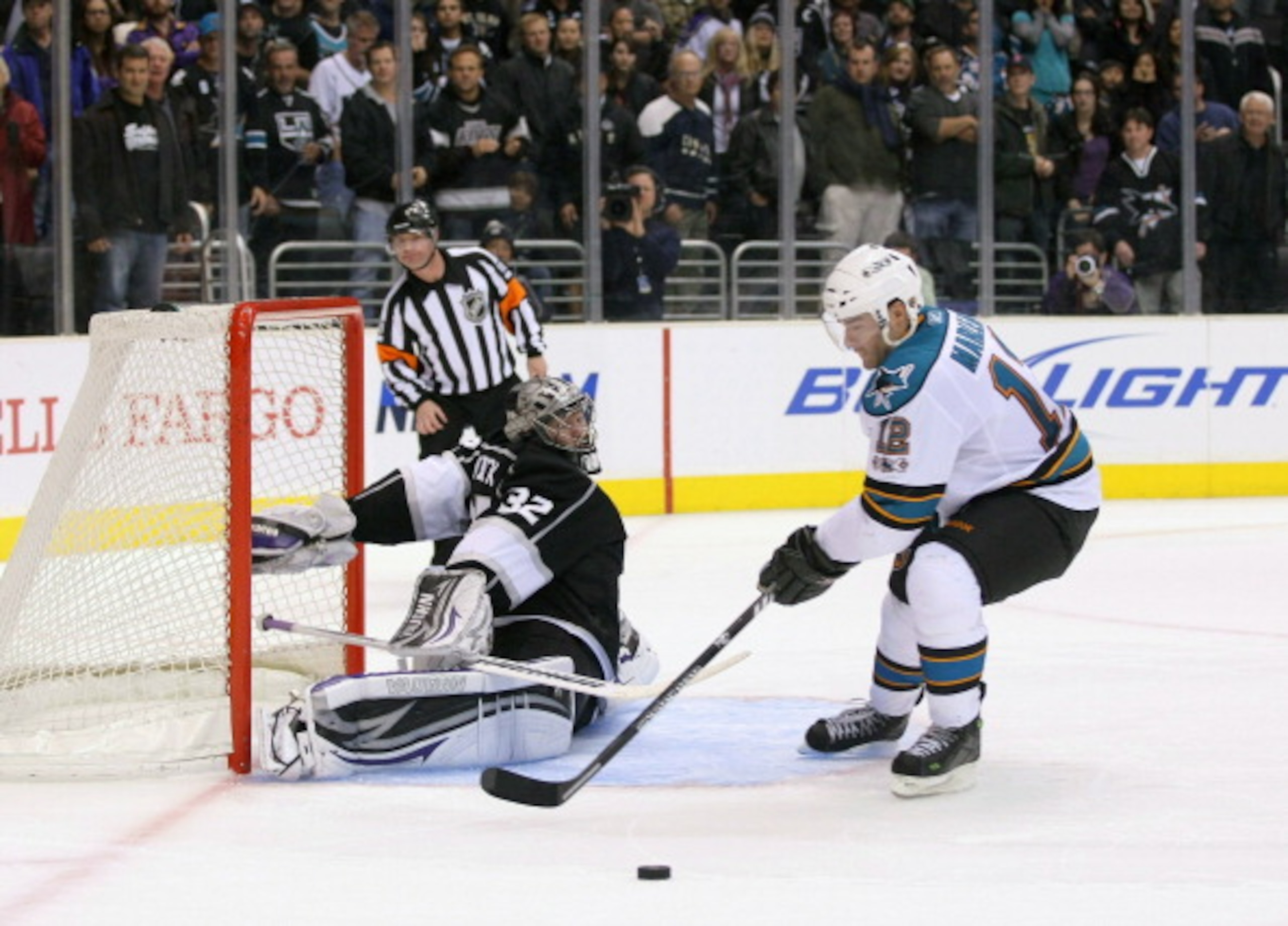 LOS ANGELES, CA - MARCH 24: Goaltender Jonathan Quick #32 of the Los Angeles Kings slides out his right leg pad to defend the shot as Patrick Marleau #12 of the San Jose Sharks loses control of the puck during his shootout attempt in the NHL game at Stap LOS ANGELES, CA - MARCH 24: Goaltender Jonathan Quick #32 of the Los Angeles Kings slides out his right leg pad to defend the shot as Patrick Marleau #12 of the San Jose Sharks loses control of the puck during his shootout attempt in the NHL game at Stap
