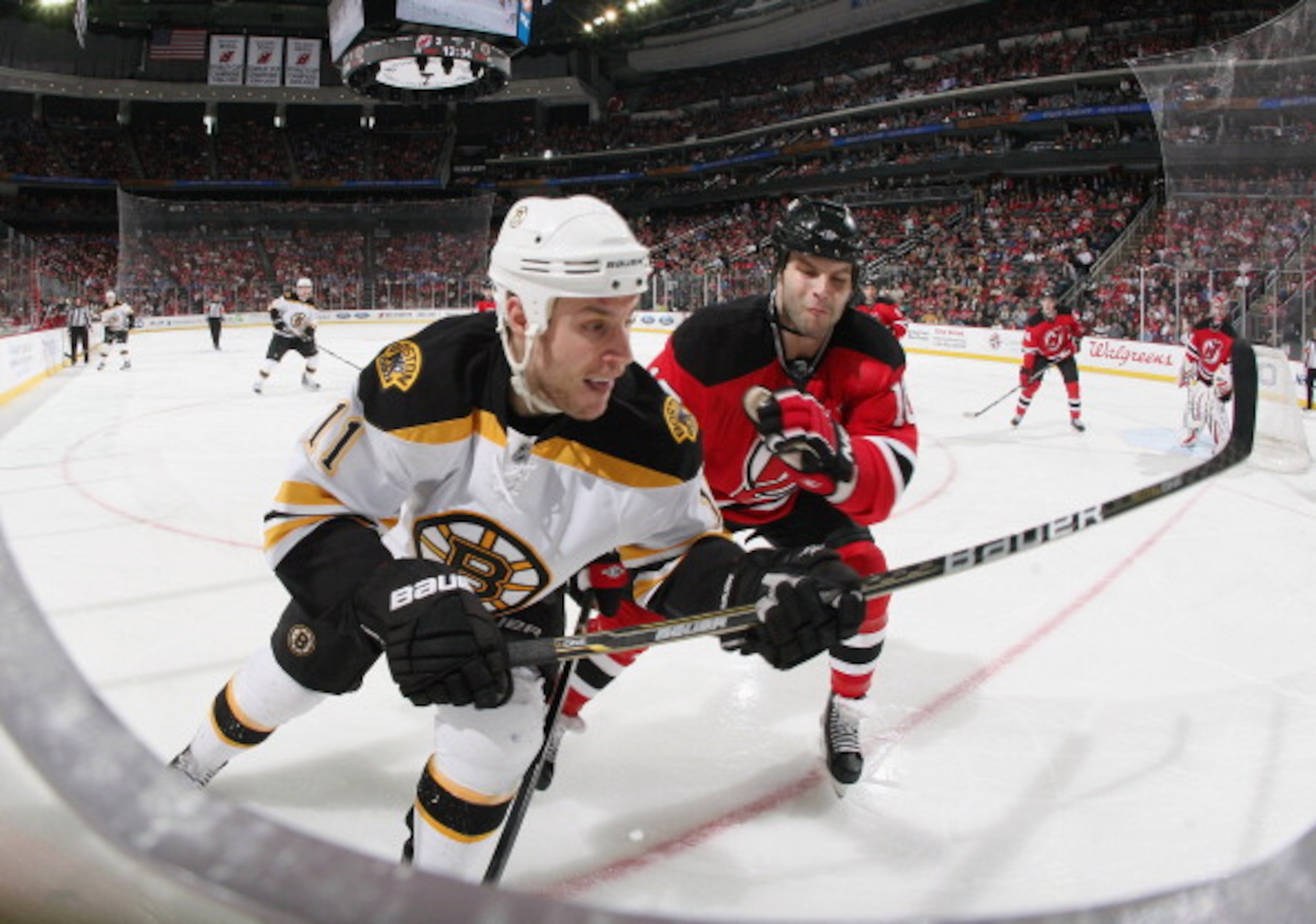 NEWARK, NJ - APRIL 10: Rod Pelley #10 of the New Jersey Devils checks Gregory Campbell #11 of the Boston Bruins at the Prudential Center on April 10, 2011 in Newark, New Jersey. The Devils defeated the Bruins 3-2. (Photo by Bruce Bennett/Getty Images) NEWARK, NJ - APRIL 10: Rod Pelley #10 of the New Jersey Devils checks Gregory Campbell #11 of the Boston Bruins at the Prudential Center on April 10, 2011 in Newark, New Jersey. The Devils defeated the Bruins 3-2. (Photo by Bruce Bennett/Getty Images)