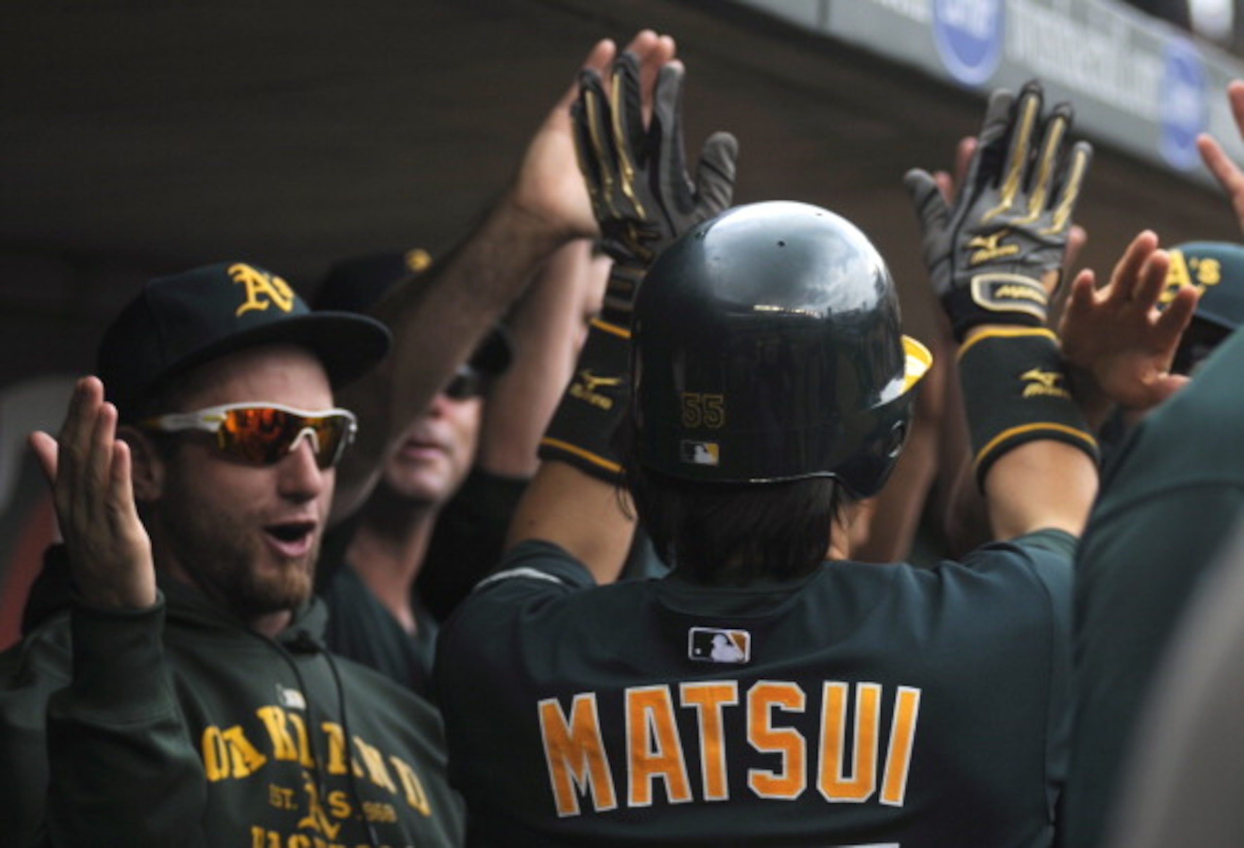 MINNEAPOLIS, MN - APRIL 10: Designated hitter Hideki Matsui #55 of the Oakland Athletics celebrates a solo home run with his teammates off starting pitcher Scott Baker #30 of the Minnesota Twins during the fourth inning of their game on April 10, 2011 at