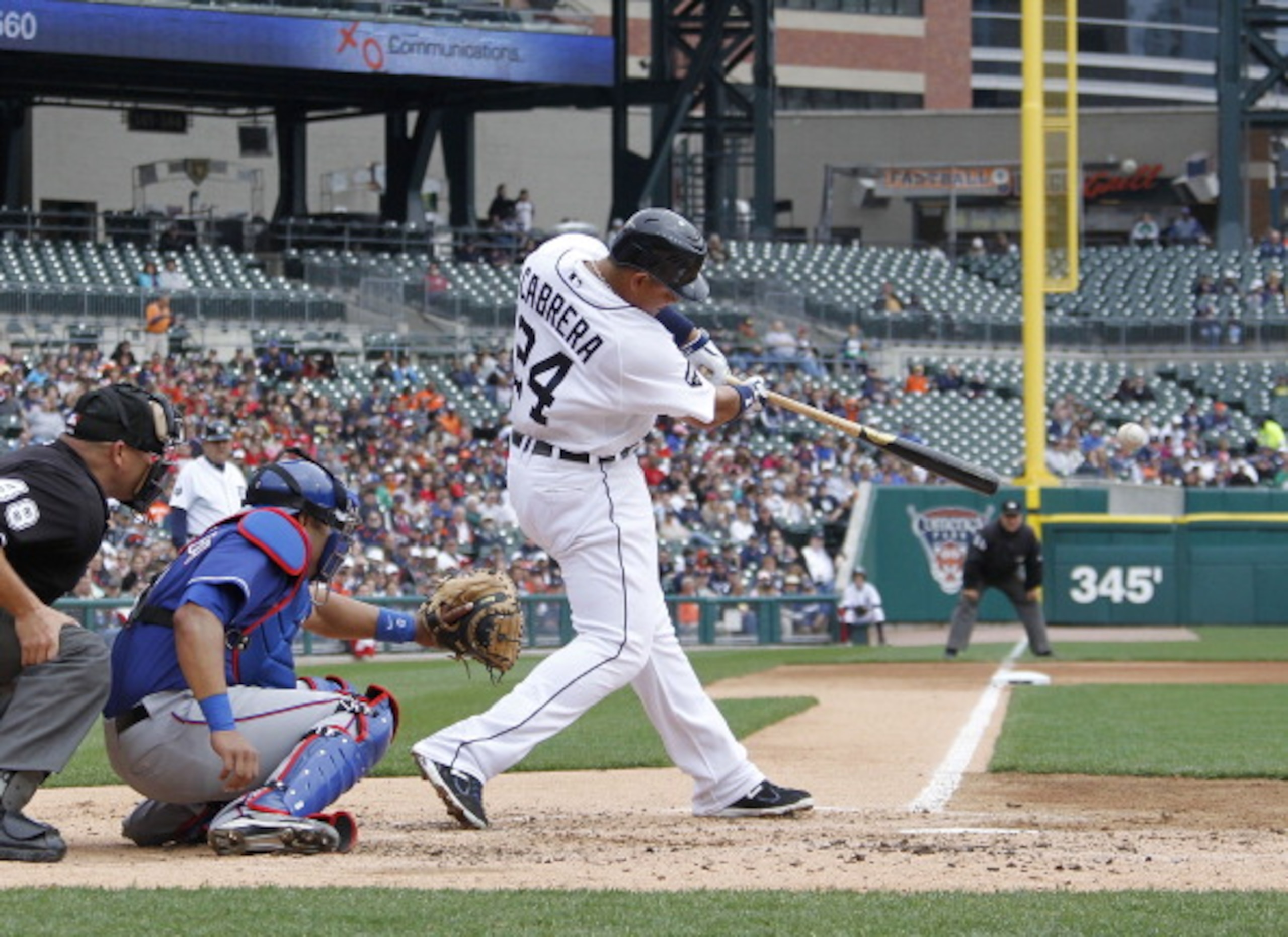 DETROIT, MI - APRIL 11:  Miguel Cabrera #24 of the Detroit Tigers hits his 300th career double in the fourth inning in front of Yorvit Torrealba #8 of the Texas Rangers at Comerica Park on April 11, 2011 in Detroit, Michigan. Texas won the game 2-0.  (Pho