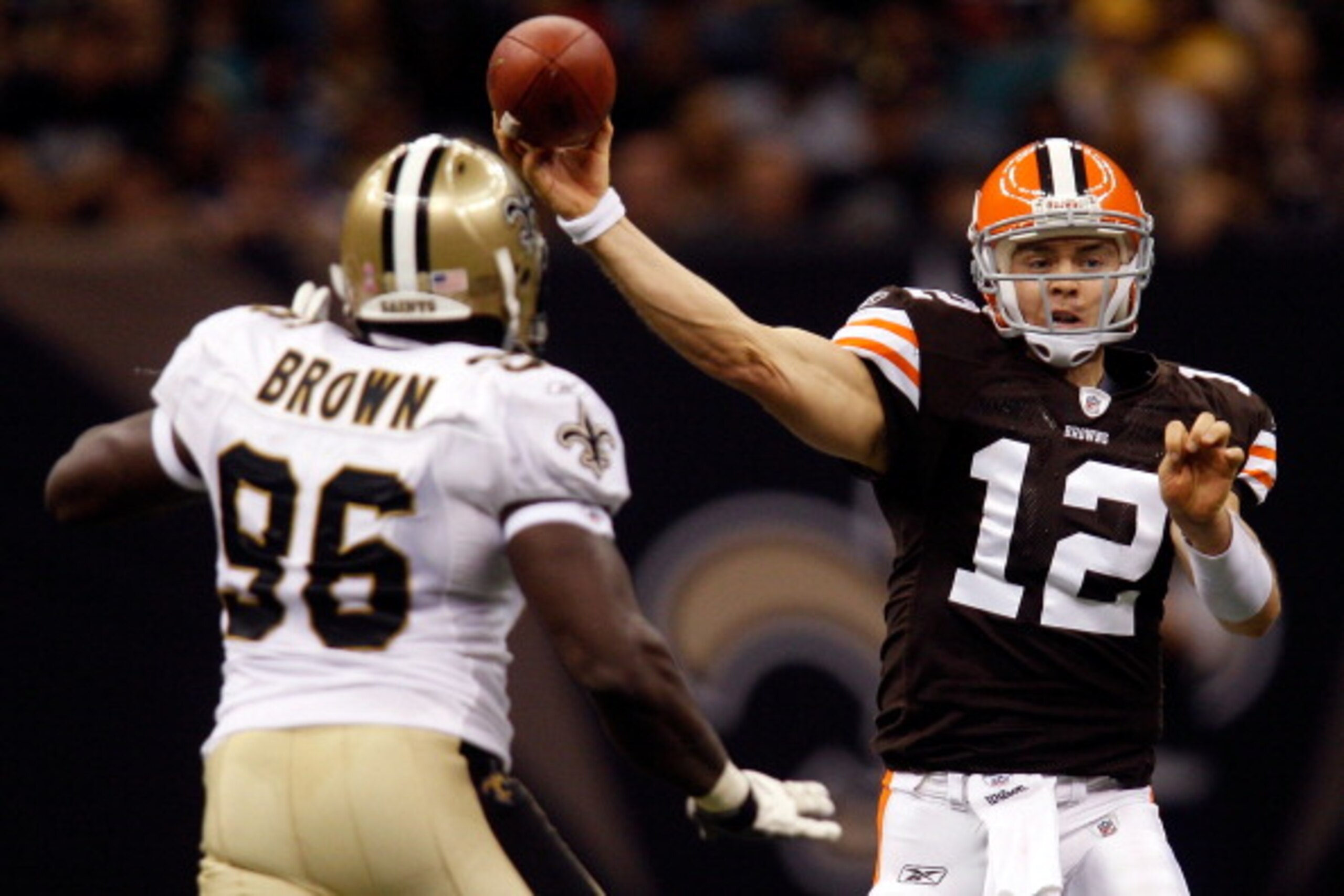 NEW ORLEANS - OCTOBER 24:  Colt McCoy #12 of the Cleveland Browns throws the ball over Alex Brown #96 of the New Orleans Saints at the Louisiana Superdome on October 24, 2010 in New Orleans, Louisiana.  The Browns defeated the Saints 30-17.  (Photo by Chr