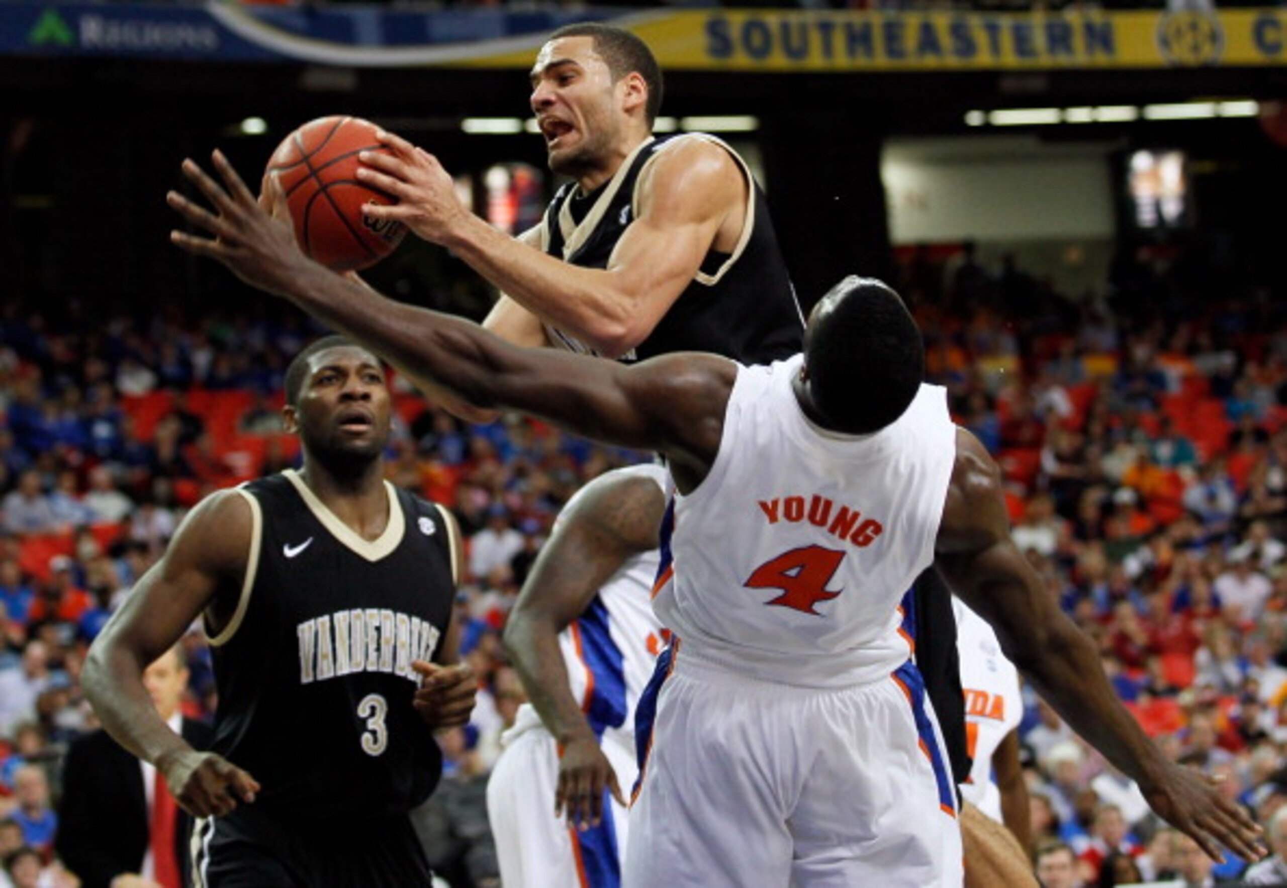 ATLANTA, GA - MARCH 12:  Jeffery Taylor #44 of the Vanderbilt Commodores goes up for a shot against Patric Young #4 of the Florida Gators during the semifinals of the SEC Men's Basketball Tournament at Georgia Dome on March 12, 2011 in Atlanta, Georgia.