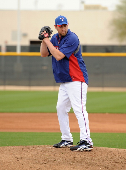 SURPRISE, AZ - FEBRUARY 18:  Brandon Webb #33 of the Texas Rangers gets ready to deliver a pitch at Surprise Stadium on February 18, 2011 in Surprise, Arizona.  (Photo by Norm Hall/Getty Images)