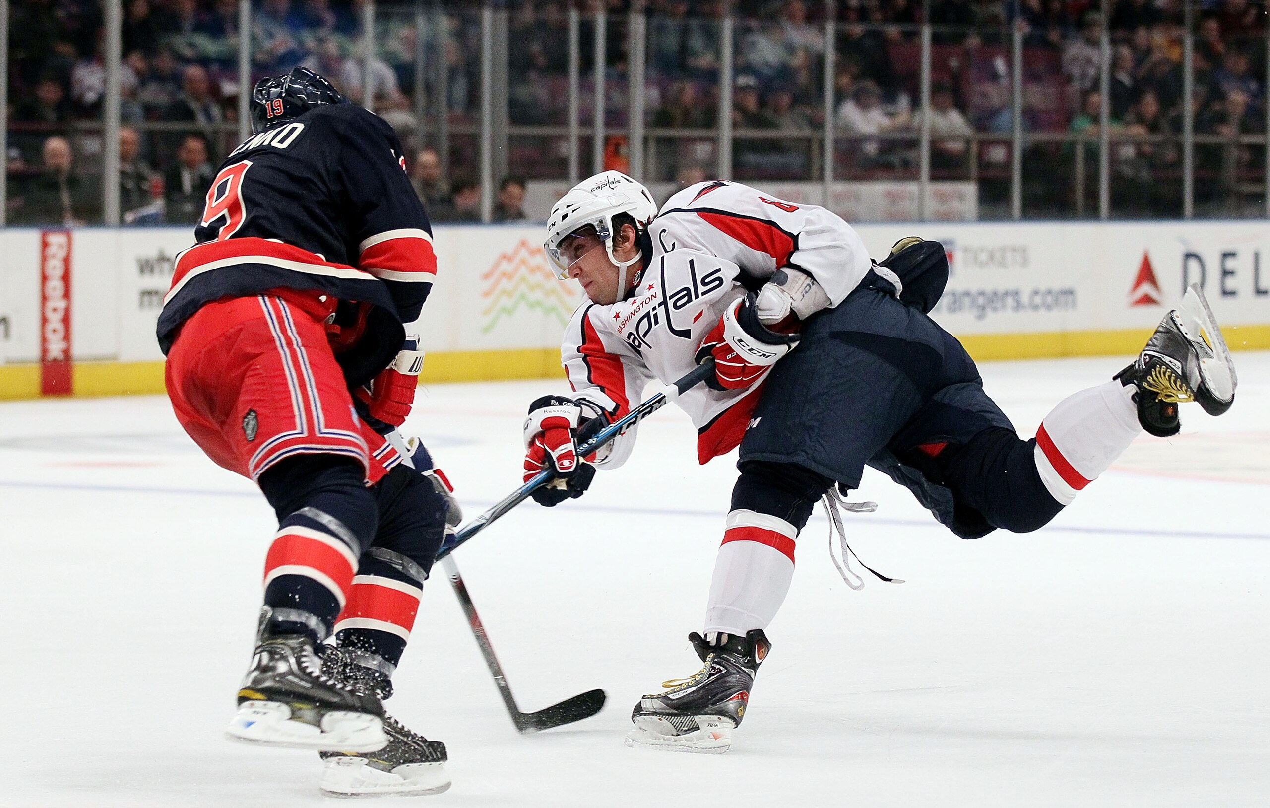 NEW YORK, NY - DECEMBER 12:  Alex Ovechkin #8 of the Washington Capitals attempts a shot against Ruslan Fedotenko #26 of the New York Rangers on December 12, 2010 at Madison Square Garden in New York City.  (Photo by Jim McIsaac/Getty Images)