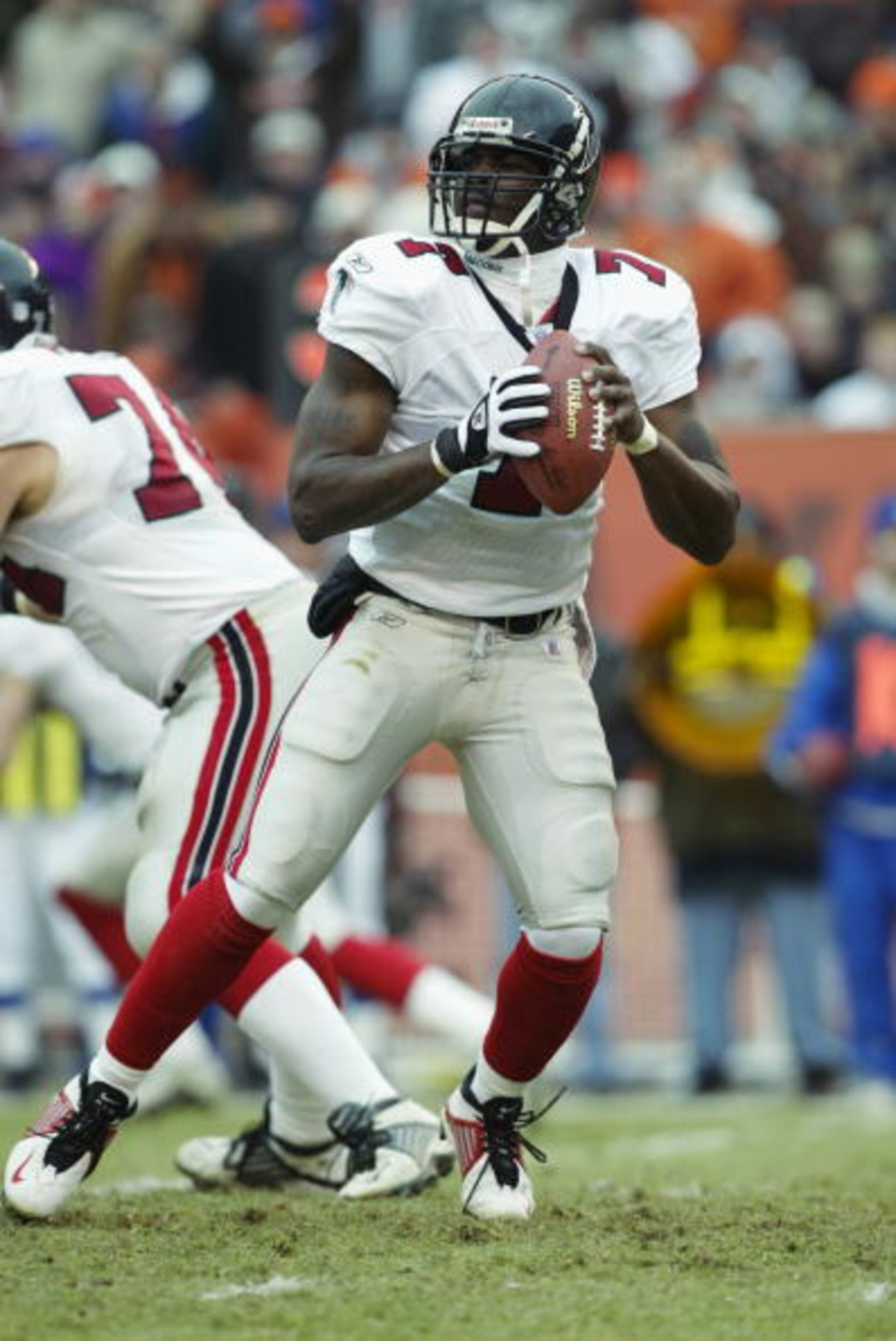 CLEVELAND - DECEMBER 29:  Quarterback Michael Vick #7 of the Atlanta Falcons drops back to pass against the Cleveland Browns during the NFL game at Cleveland Browns Stadium on December 29, 2002 in Cleveland, Ohio.  The Browns defeated the Falcons 24-16.