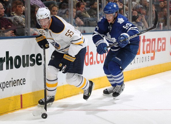 TORONTO, CANADA - MARCH 12:  Jochen Hecht #55 of the Buffalo Sabres controls the puck in front of Keith Aulie #59 of the Toronto Maple Leafs in a game on March 12, 2011 at the Air Canada Centre in Toronto, Canada. The Leafs defeated the Sabres 4-3. (Photo