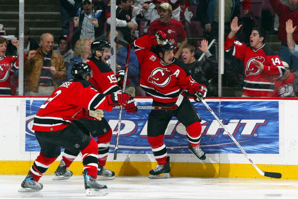 EAST RUTHERFORD, NJ - APRIL 28:  Jamie Langenbrunner #15 of the New Jersey Devils celebrates his double overtime game winning goal with Zach Parise #9 and Travis Zajac #19 to defeat the Ottawa Senators 3-2 to win Game 2 of the 2007 Eastern Conference Semi