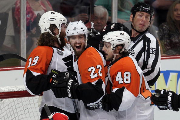 CHICAGO - MAY 29:  (C) Ville Leino #22 of the Philadelphia Flyers celebrates with teammates Scott Hartnell #19 and Danny Briere #48 after scoring a first period goal against the Chicago Blackhawks in Game One of the 2010 NHL Stanley Cup Final at the Unite