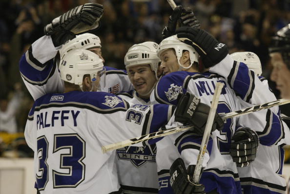 LOS ANGELES - JANUARY 24:  Adam Deadmarsh #28 (m) of the Los Angeles Kings celebrates with teammates Ziggy Palffy #33, Jason Allison (rear), Aaron Miller #3 and Lubomir Visnovsky (r) on a goal against the Minnesota Wild during the game on January 24, 2002