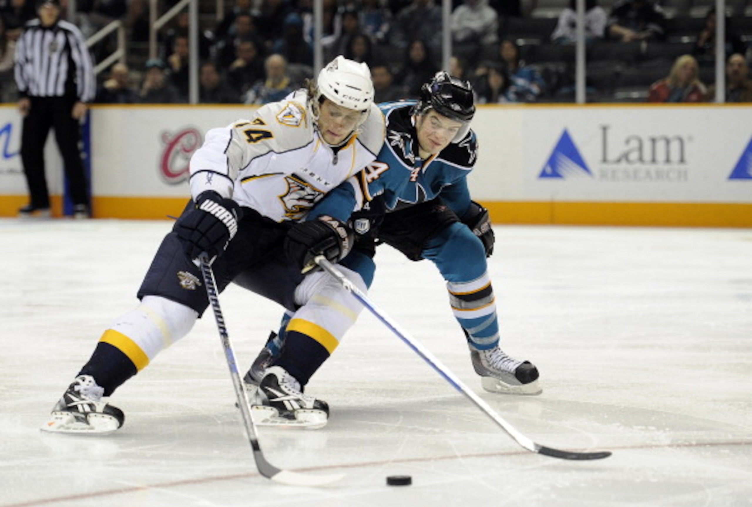 SAN JOSE, CA - MARCH 8: Sergei Kostitsyn #74 of the Nashville Predators on a break away has the puck slapped away by Marc-Edouard Vlasic #44 of the San Jose Sharks in third period of an NHL hockey game at the HP Pavilion on March 8, 2011 in San Jose, Cali