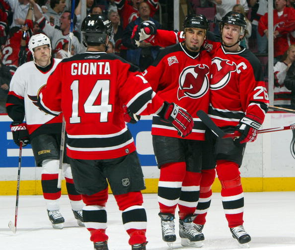EAST RUTHERFORD, NJ - MAY 5: Scott Gomez #23 of the New Jersey Devils celebrates his first-period goal with teammates Brian Gionta #14 and Patrik Elias #26 against the Ottawa Senators during Game Five of the 2007 Eastern Conference Semifinals at the Conti