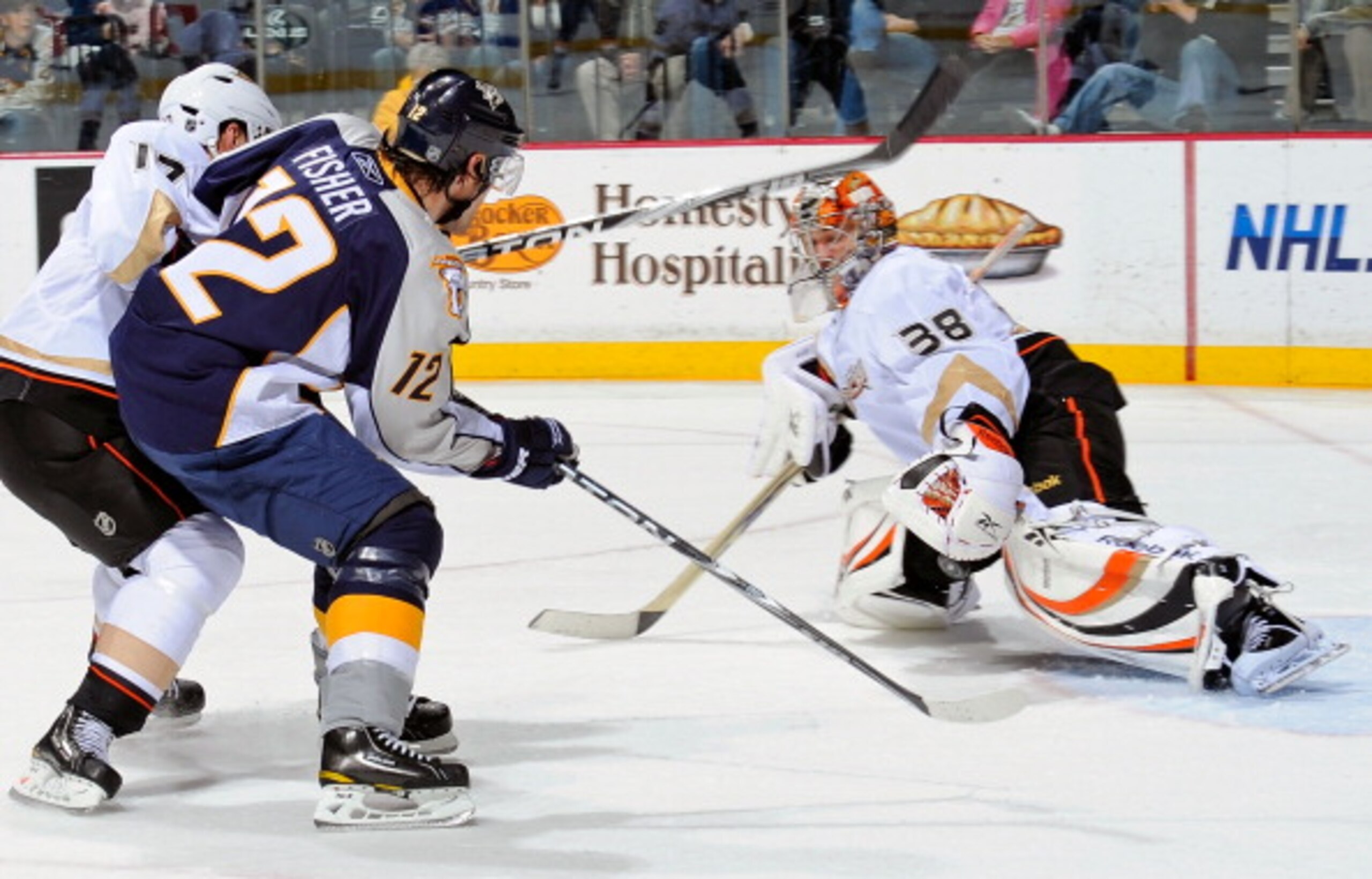 NASHVILLE, TN - MARCH 24:  Dan Ellis #39 of the Anaheim Ducks makes a save on Mike Fisher #12 of the Nashville Predators on March 24, 2011 at the Bridgestone Arena in Nashville, Tennessee.  (Photo by Frederick Breedon/Getty Images)