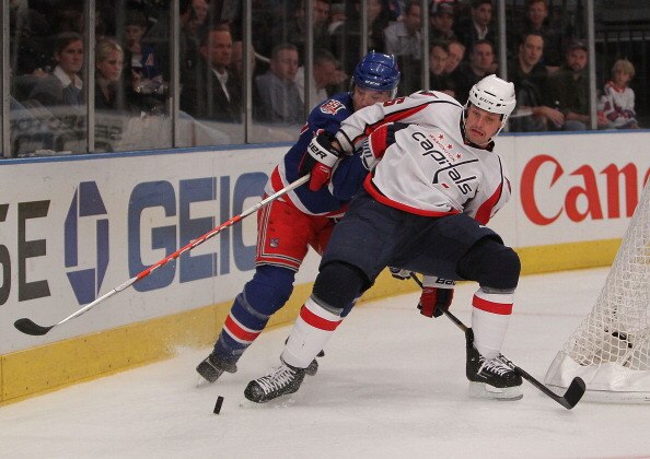 NEW YORK - NOVEMBER 09:  Matt Hendricks #26 of the Washington Capitals is challenged by Michael Sauer #38 of the New York Rangers at Madison Square Garden on November 9, 2010 in New York City.  (Photo by Nick Laham/Getty Images)