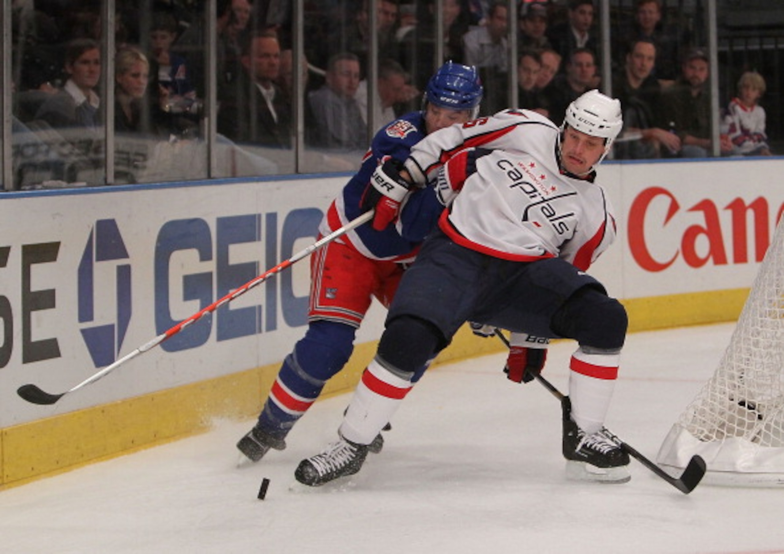 NEW YORK - NOVEMBER 09:  Matt Hendricks #26 of the Washington Capitals is challenged by Michael Sauer #38 of the New York Rangers at Madison Square Garden on November 9, 2010 in New York City.  (Photo by Nick Laham/Getty Images)