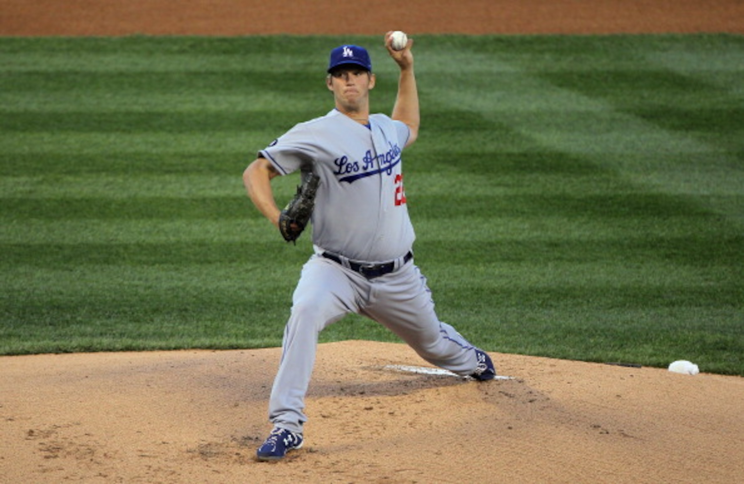 DENVER, CO - APRIL 05:  Starting pitcher Clayton Kershaw #22 of the Los Angeles Dodgers delivers against the Colorado Rockies at Coors Field on April 5, 2011 in Denver, Colorado. Kershaw collected the loss as the Rockies defeated the Dodgers 3-0.  (Photo