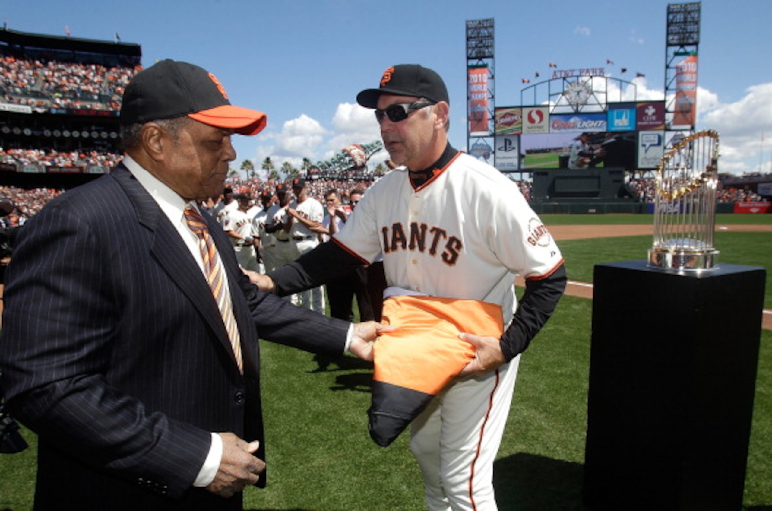 SAN FRANCISCO, CA - APRIL 08:  San Francisco Giants manager Bruce Bochy accepts the 2010 World Series flag from former San Francisco Giants player Willie Mayes before the start of the Giants' opening day game against the St. Louis Cardinals at AT&T Park o