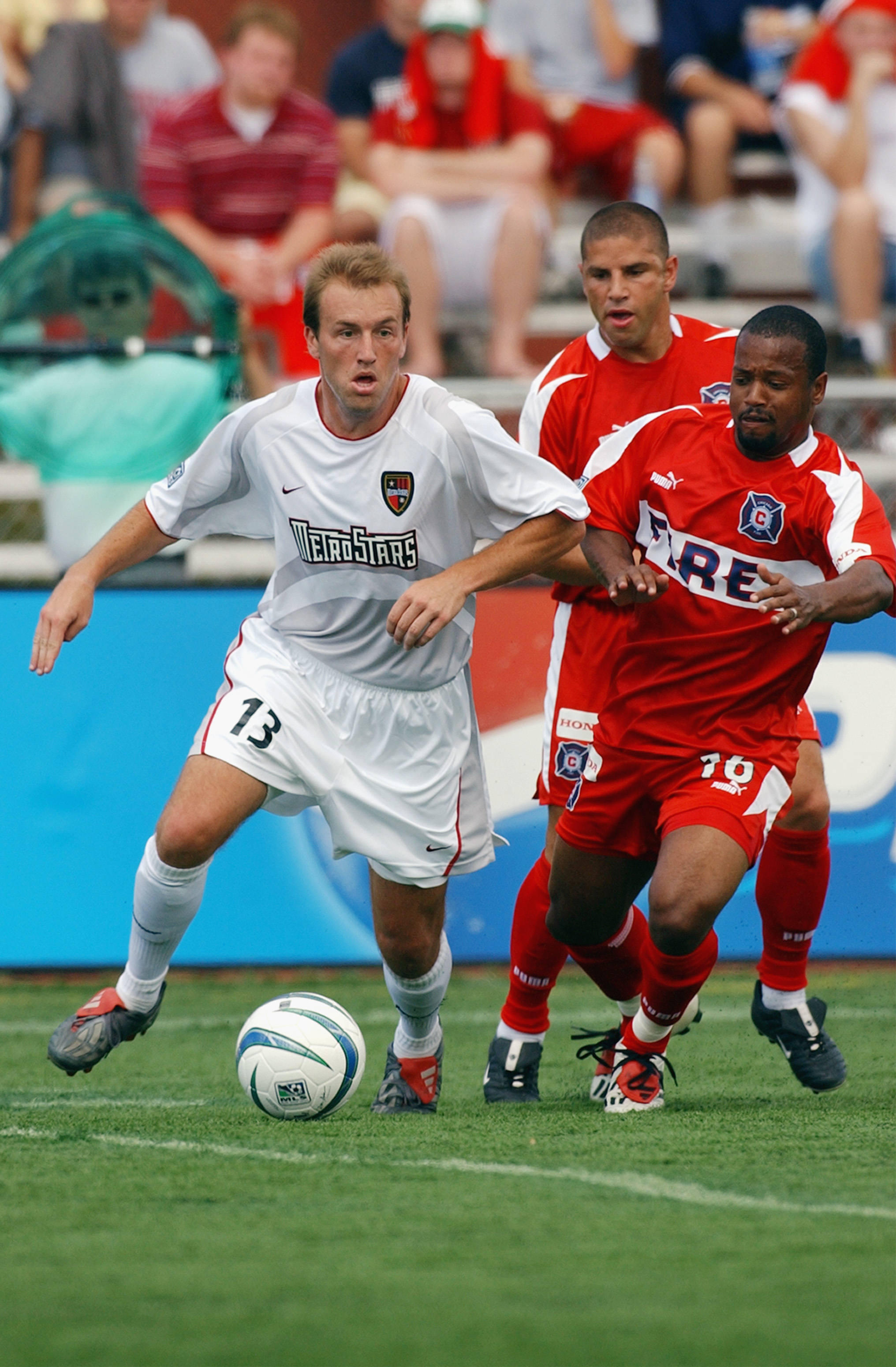 NAPERVILLE, IL - JUNE 28:  Andy Williams #16 of the Chicago Fire defends Clint Mathis #13 of the NY/NJ MetroStars during their MLS game on June 28, 2003 at Cardinal Stadium in Naperville, Illinois. The Fire defeated the MetroStars 2-1 in overtime. (Photo