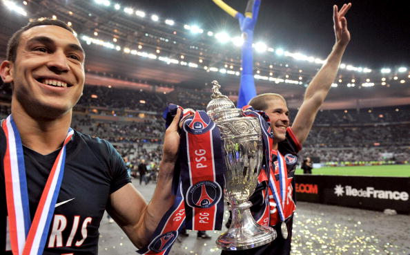 PARIS - MAY 01:  Striker Mevlut Erding of Paris Saint Germain football club (L) and midfielder Christophe Jallet (R) hold the trophy after winning the French Cup Football Final at Stade de France on May 1, 2010 in Paris, France.  (Photo by Pascal Le Segre