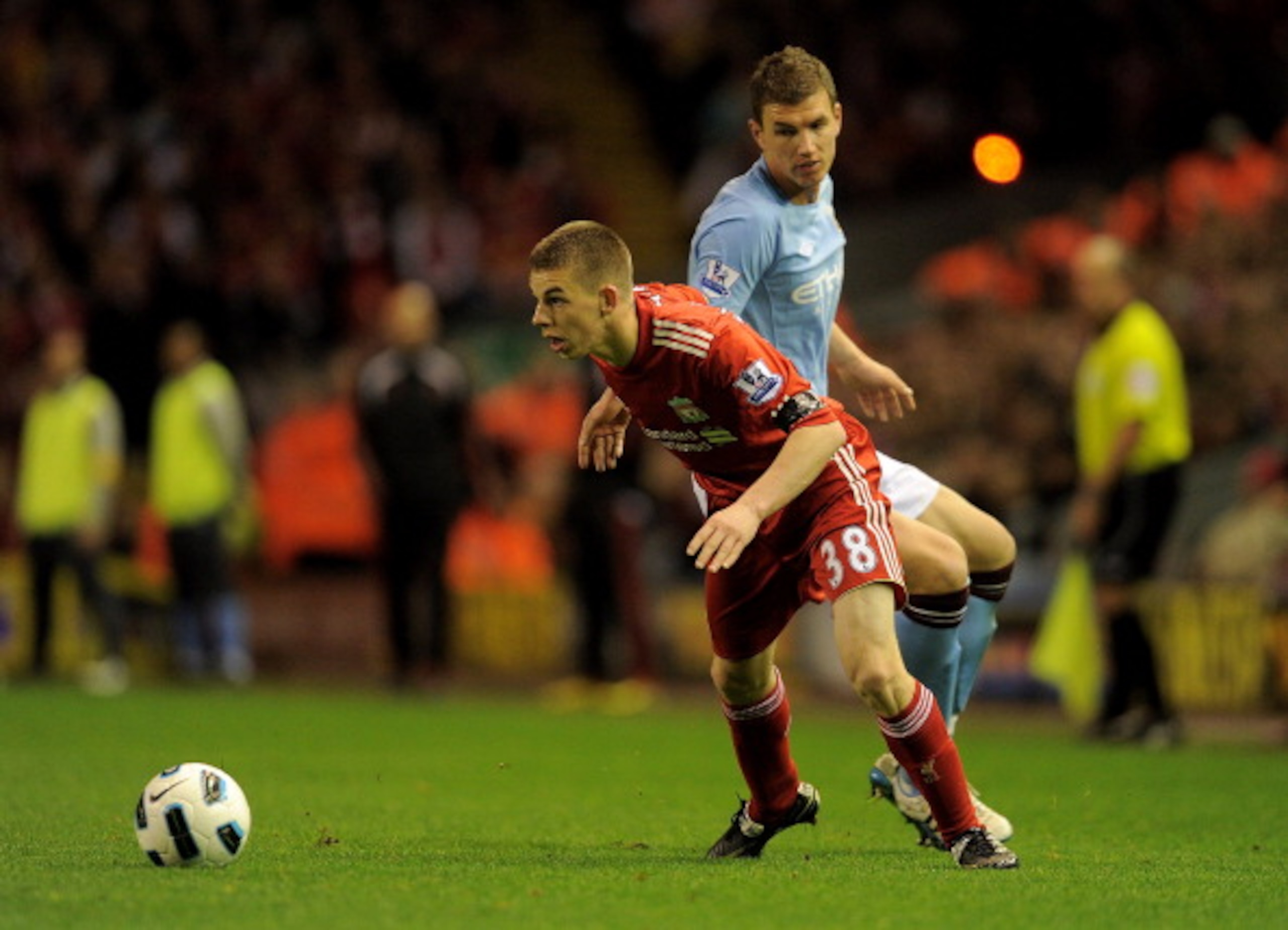 LIVERPOOL, ENGLAND - APRIL 11:   John Flanagan of Liverpool competes with Edin Dzeko of Manchester City during the Barclays Premier League match between Liverpool and Manchester City at Anfield on April 11, 2011 in Liverpool, England. (Photo by Michael Re