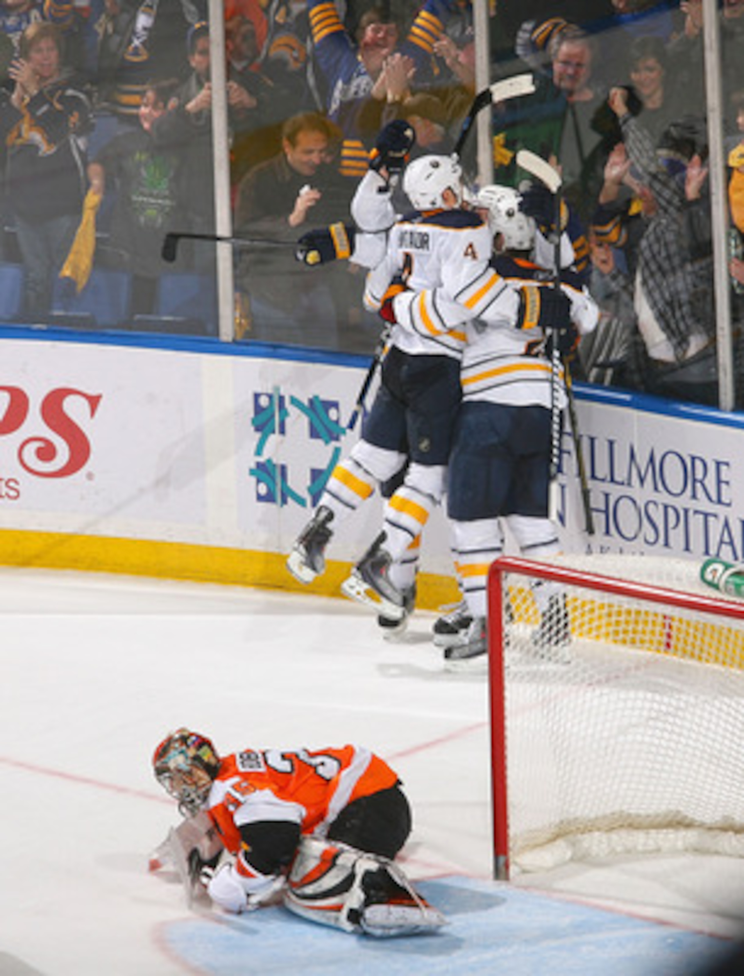 BUFFALO, NY - APRIL 08: Players from the Buffalo Sabres skate to Thomas Vanek #26  after Vanek scored the game winning goal in overtime against Sergei Bobrovsky #35 of the Philadelphia Flyers at HSBC Arena on April 8, 2011 in Buffalo, New York. Buffalo wo