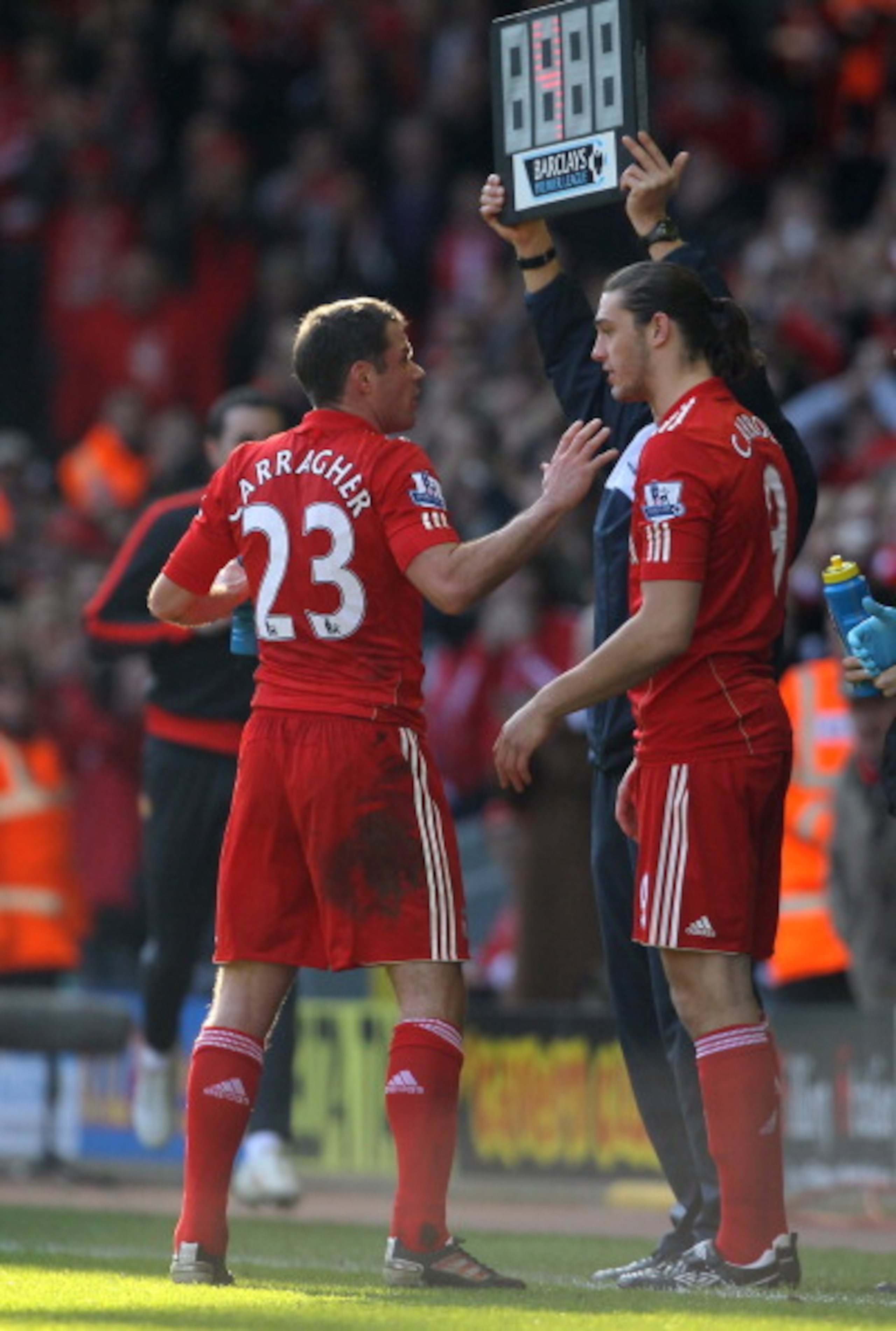 LIVERPOOL, UNITED KINGDOM - MARCH 06:  Andy Carroll of Liverpool speaks to team mate Jamie Carragher before coming on as a substitute to make his debut during the Barclays Premier League match between Liverpool and Manchester United at Anfield on March 6,