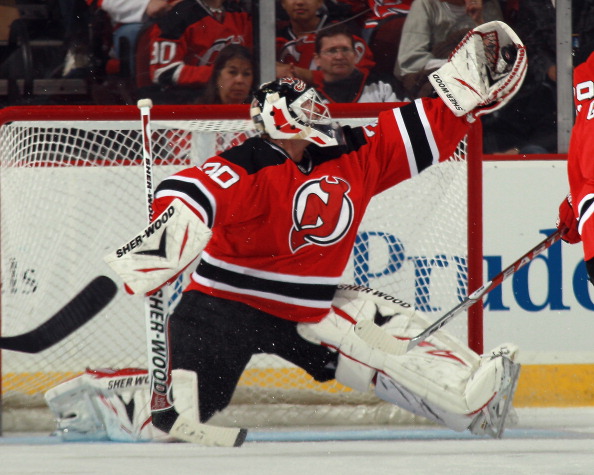 NEWARK, NJ - MARCH 30: Martin Brodeur #30 of the New Jersey Devils comes up with the puck during the second period against the New York Islanders at the Prudential Center on March 30, 2011 in Newark, New Jersey.  (Photo by Bruce Bennett/Getty Images)