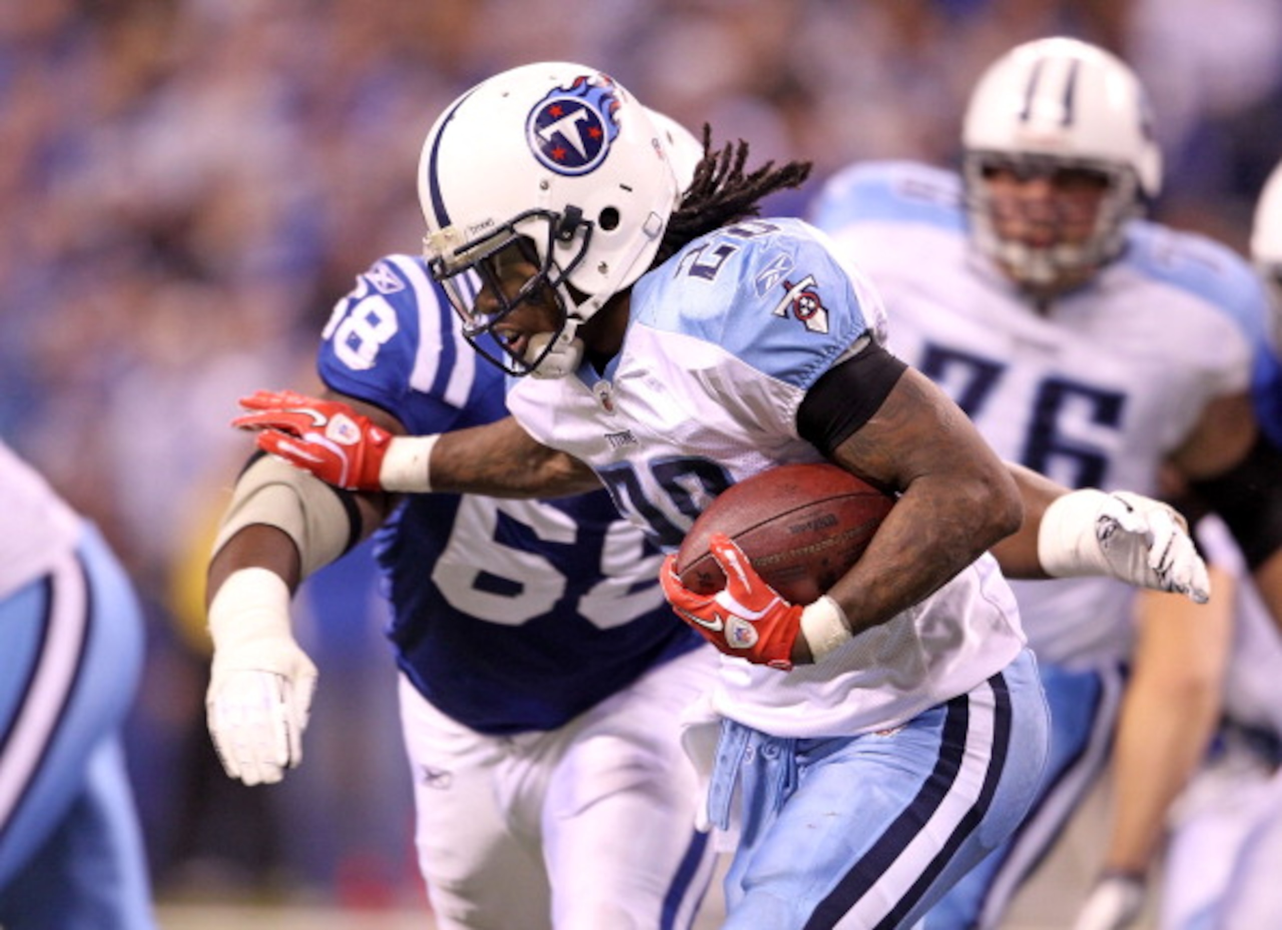 INDIANAPOLIS - JANUARY 02:  Chris Johnson #28 of the Tennessee Titans is tackled by Eric Foster #68 of the Indianapolis Colts at Lucas Oil Stadium on January 2, 2011 in Indianapolis, Indiana.  the Colts won 23-20.  (Photo by Andy Lyons/Getty Images)