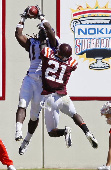 BLACKSBURG, VA - SEPTEMBER 18:  Wide receiver Dwayne Harris #17 of the East Carolina Pirates catches a touchdown pass as cornerback Rashad Carmichael #21 of the Virginia Tech Hokies defends at Lane Stadium on September 18, 2010 in Blacksburg, Virginia.  (