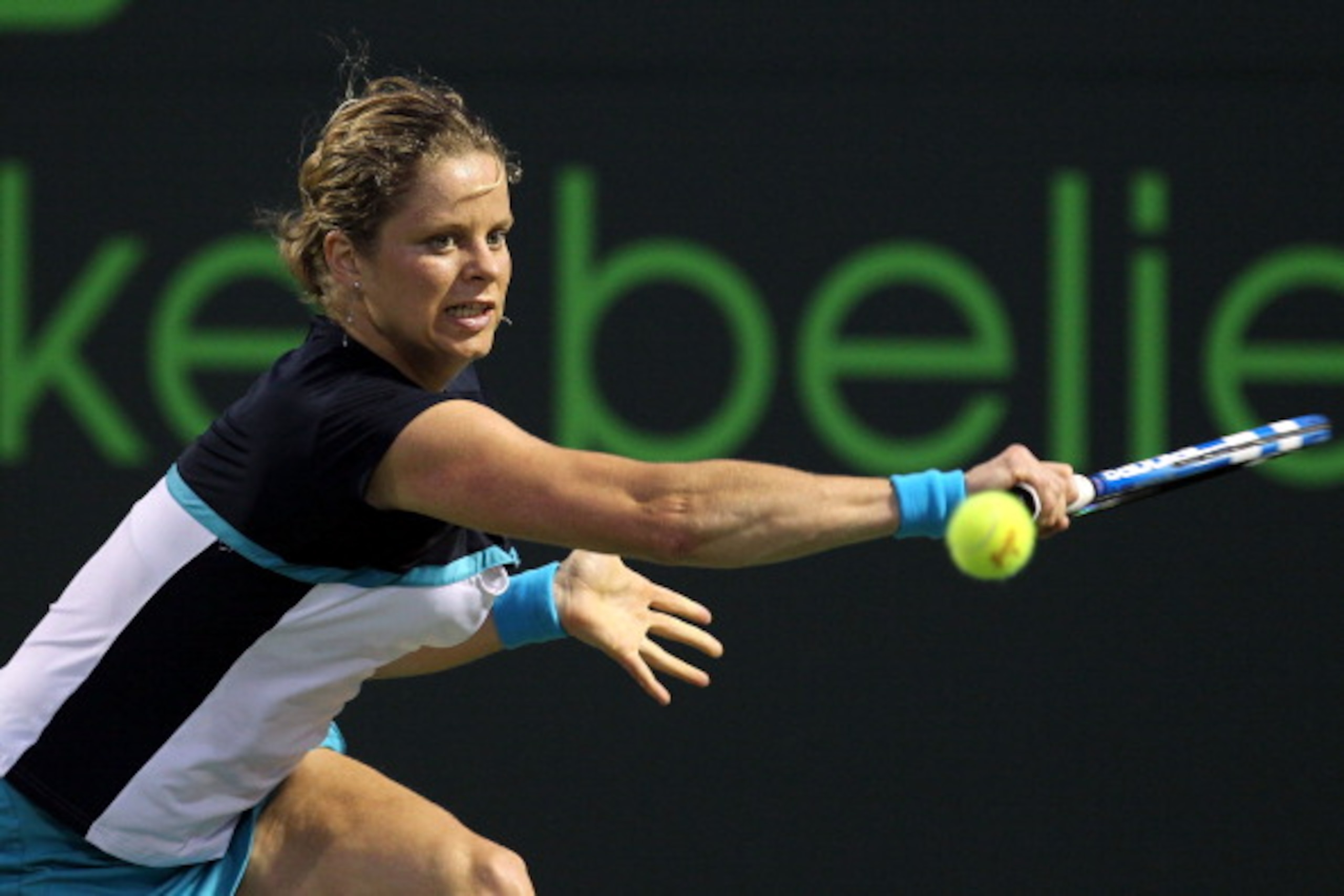 KEY BISCAYNE, FL - MARCH 30: Kim Clijsters of Belgium stretches for a backhand return against Victoria Azarenka of Belarus during the Sony Ericsson Open at Crandon Park Tennis Center on March 30, 2011 in Key Biscayne, Florida. (Photo by Al Bello/Getty I KEY BISCAYNE, FL - MARCH 30: Kim Clijsters of Belgium stretches for a backhand return against Victoria Azarenka of Belarus during the Sony Ericsson Open at Crandon Park Tennis Center on March 30, 2011 in Key Biscayne, Florida. (Photo by Al Bello/Getty I