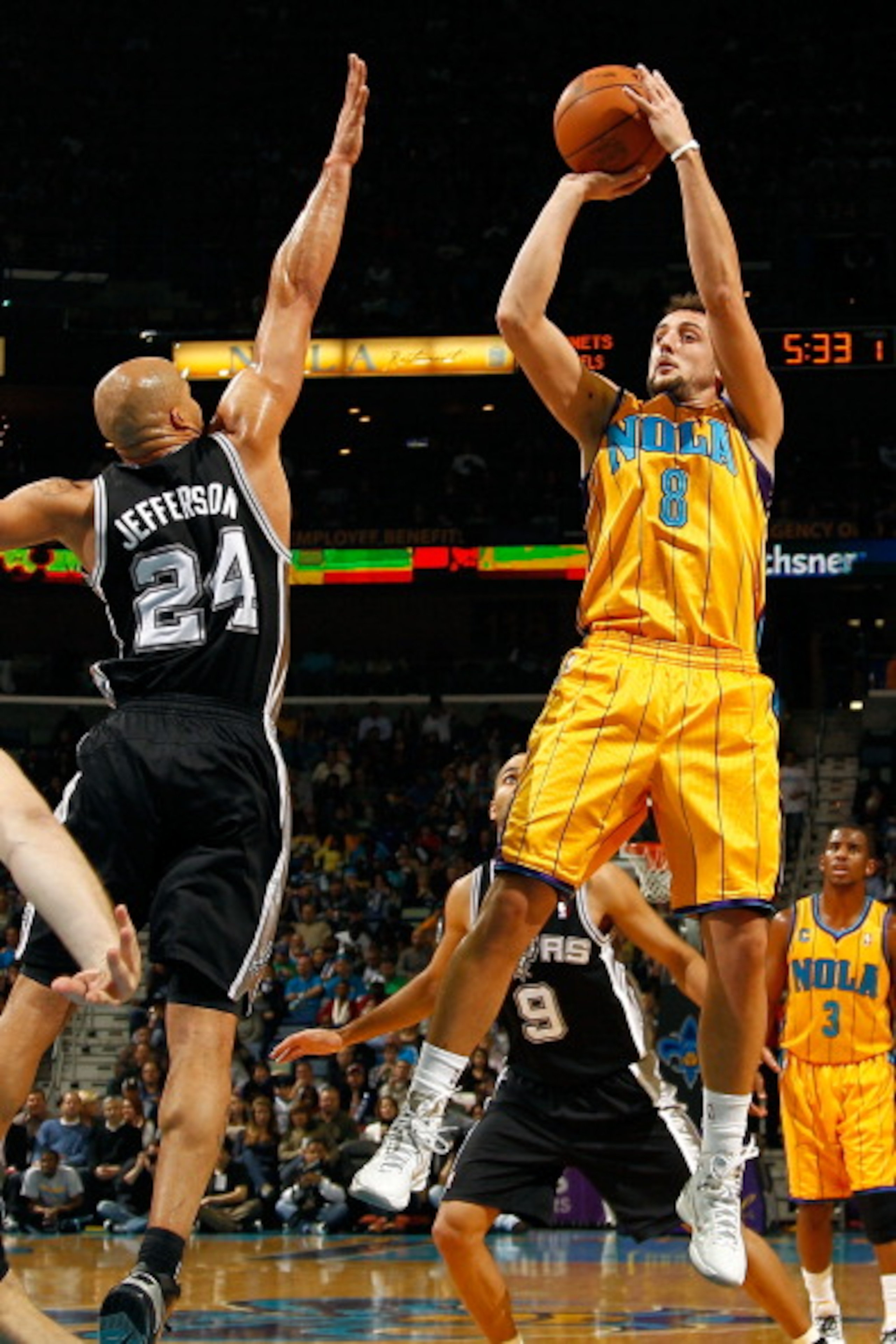 NEW ORLEANS, LA - JANUARY 22:  Marco Belinelli #8 of the New Orleans Hornets shoots the ball over Richard Jefferson #24  of the San Antonio Spurs at the New Orleans Arena on January 22, 2011 in New Orleans, Louisiana.  NOTE TO USER: User expressly acknowl