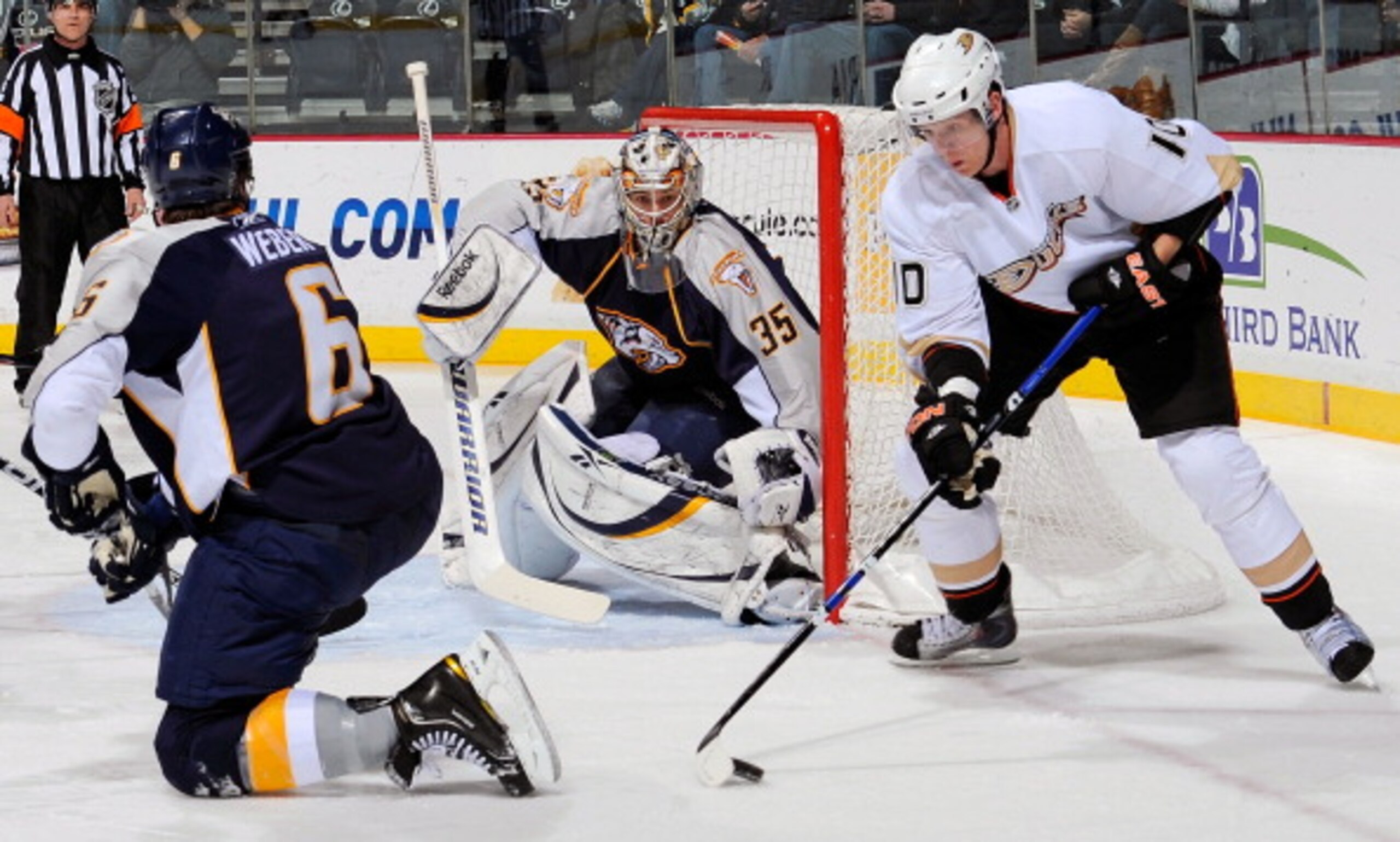 NASHVILLE, TN - MARCH 24:  Corey Perry #10 of the Anaheim Ducks plays the puck between Shea Weber #6 and Pekka Rinne #35 of the Nashville Predators on March 24, 2011 at the Bridgestone Arena in Nashville, Tennessee.  (Photo by Frederick Breedon/Getty Imag