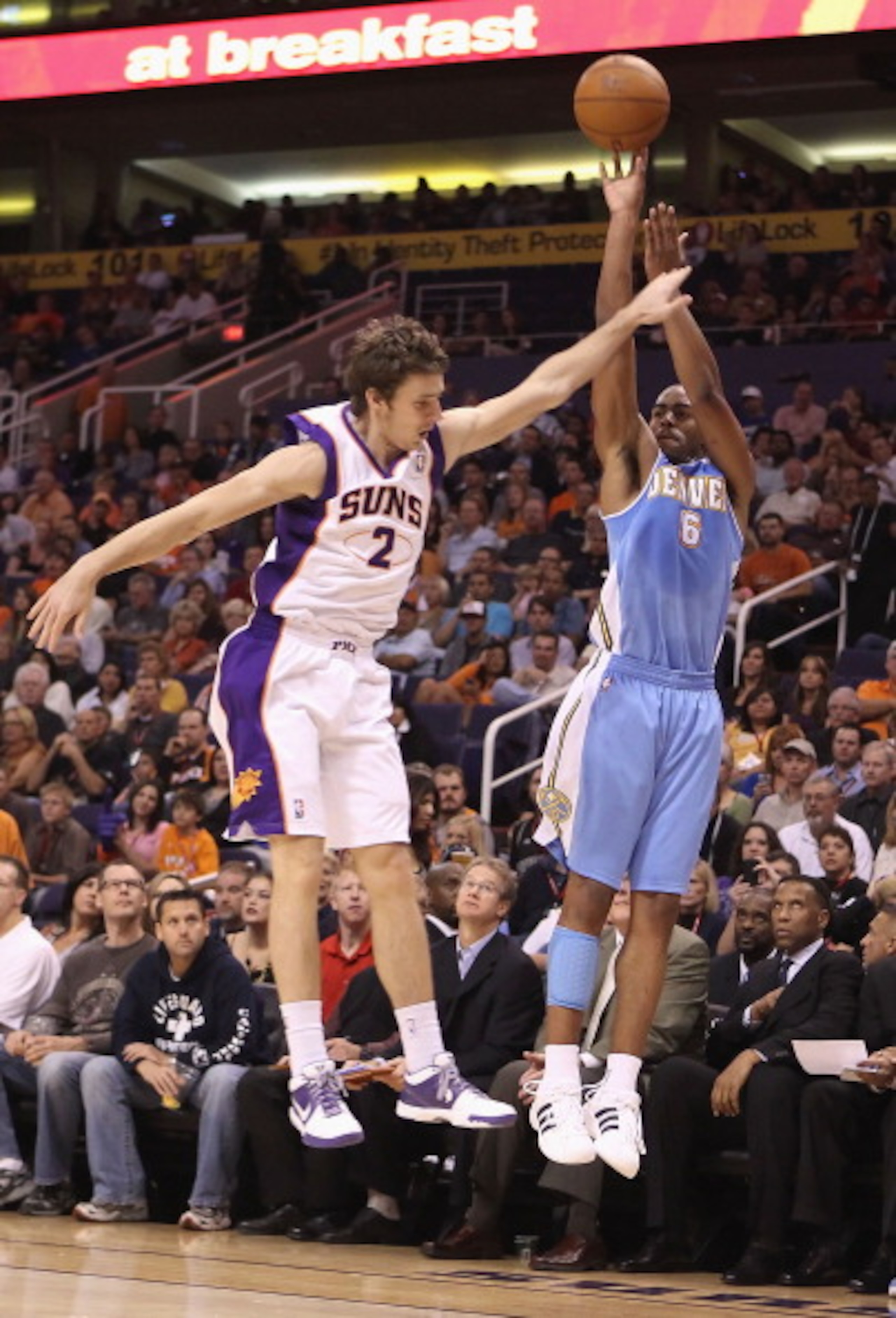 PHOENIX - OCTOBER 22:  Arron Afflalo #6 of the Denver Nuggets puts up a three point shot over Goran Dragic #2 of the Phoenix Suns during the preseason NBA game at US Airways Center on October 22, 2010 in Phoenix, Arizona. NOTE TO USER: User expressly ackn