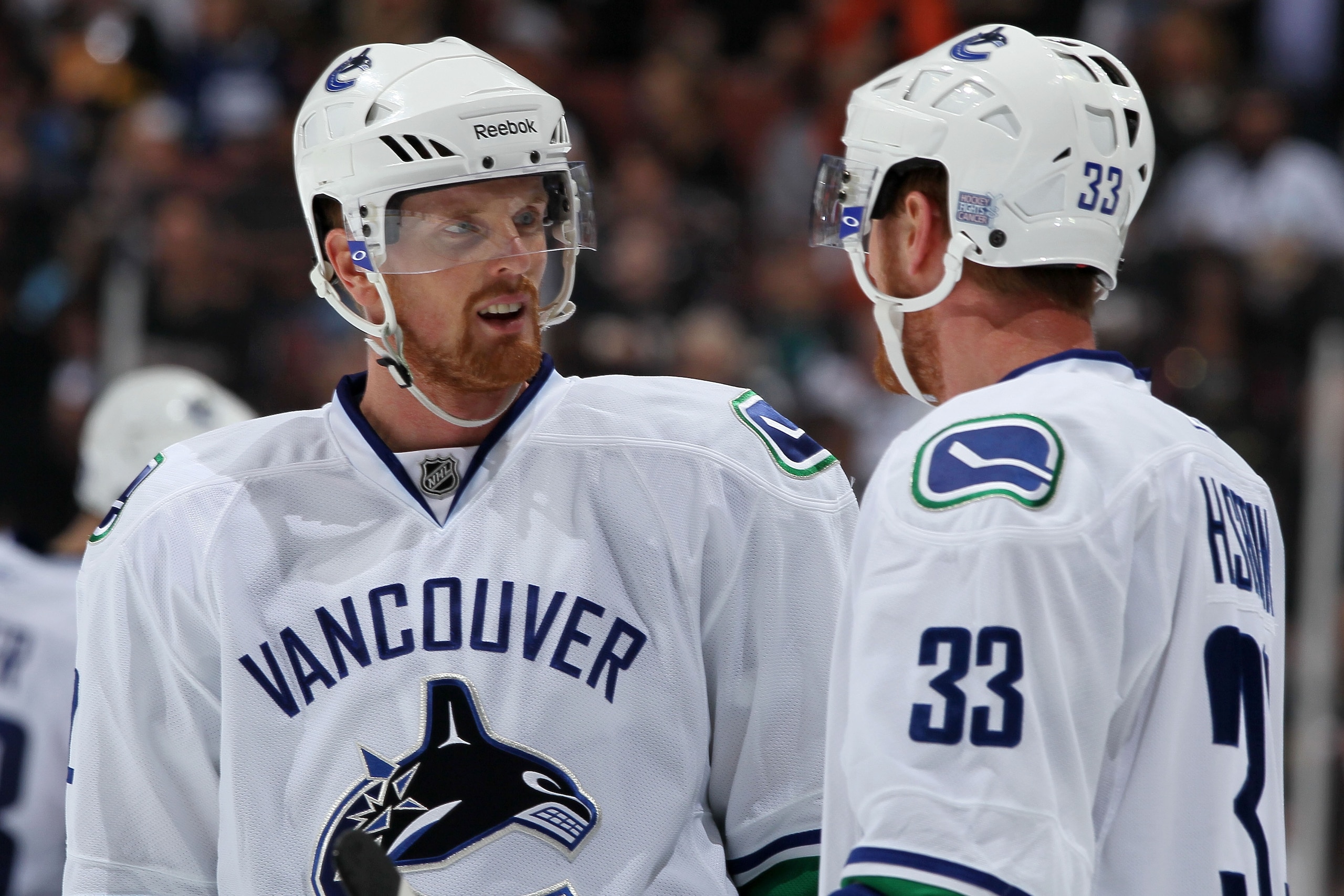 ANAHEIM, CA - OCTOBER 13:  (L-R) Brothers Daniel Sedin #22 and Henrik Sedin #33 of the Vancouver Canucks speak during their game against the Anaheim Ducks at Honda Center on October 13, 2010 in Anaheim, California.  (Photo by Jeff Gross/Getty Images)