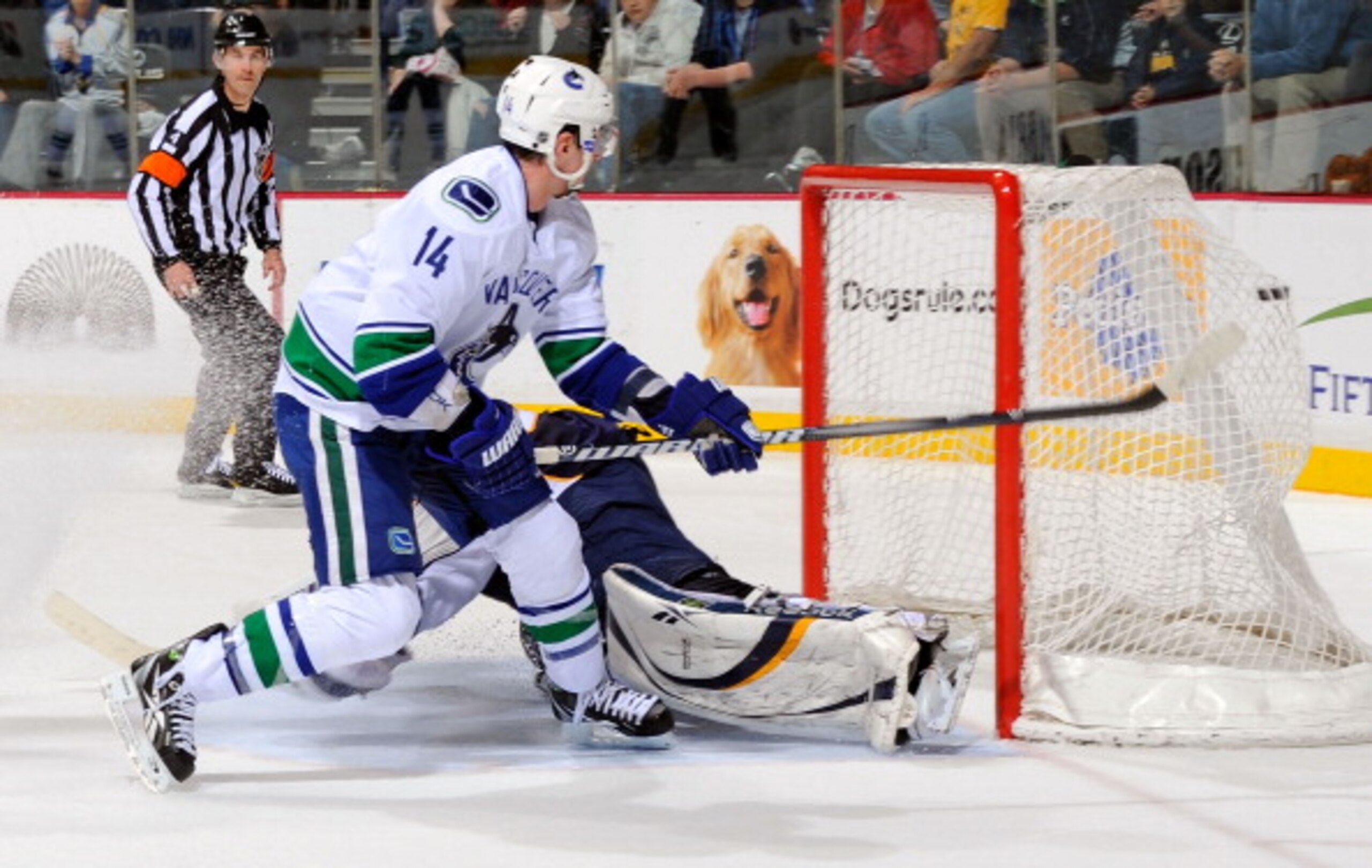 NASHVILLE, TN - MARCH 29:  Alexandre Burrows #14 of the Vancouver Canucks scores the game winning goal on a breakaway against Pekka Rinne #35 of the Nashville Predators on March 29, 2011 at the Bridgestone Arena in Nashville, Tennessee.  (Photo by Frederi