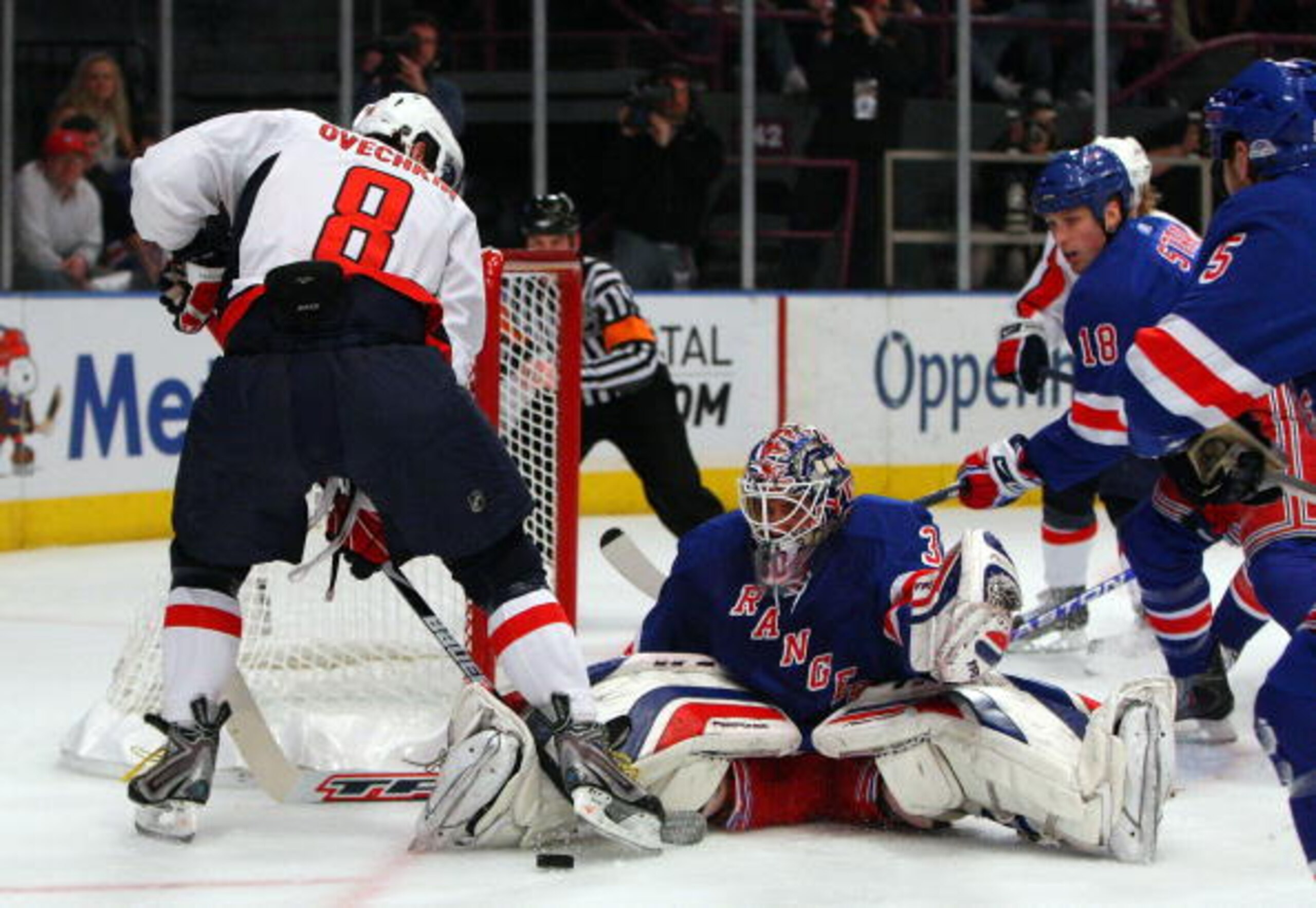 NEW YORK - APRIL 22:  Henrik Lundqvist #30 of the New York Rangers makes a save against Alex Ovechkin #8 of the Washington Capitals during Game Four of the Eastern Conference Quarterfinal Round of the 2009 NHL Stanley Cup Playoffs on April 22, 2008 at Mad